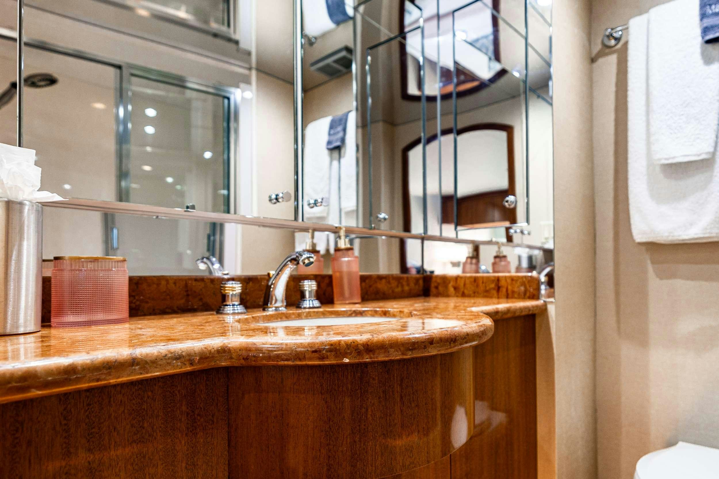 a bathroom with a sink and a mirror aboard INDY Yacht for Charter