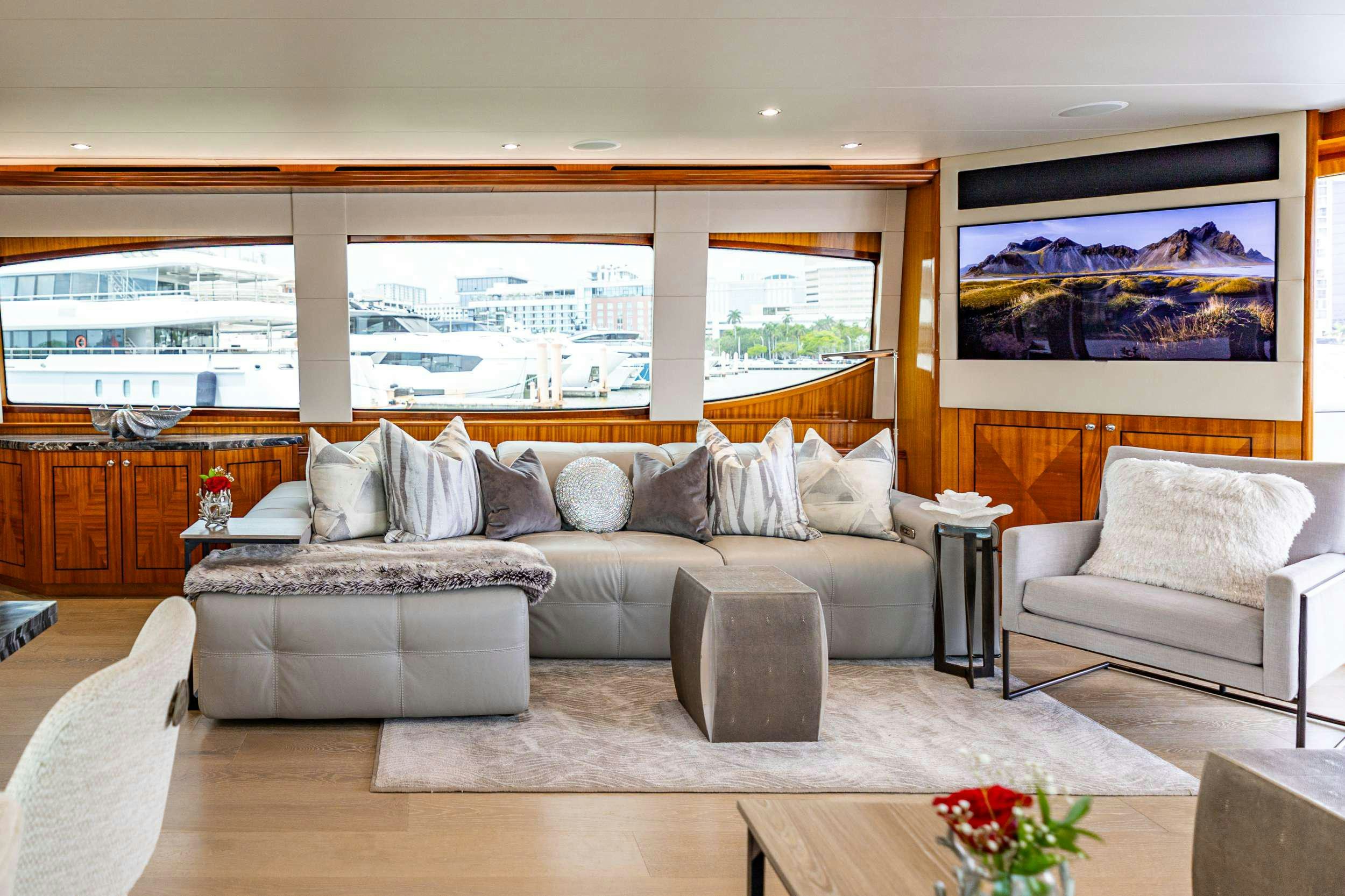 a living room with a large window aboard INDY Yacht for Charter