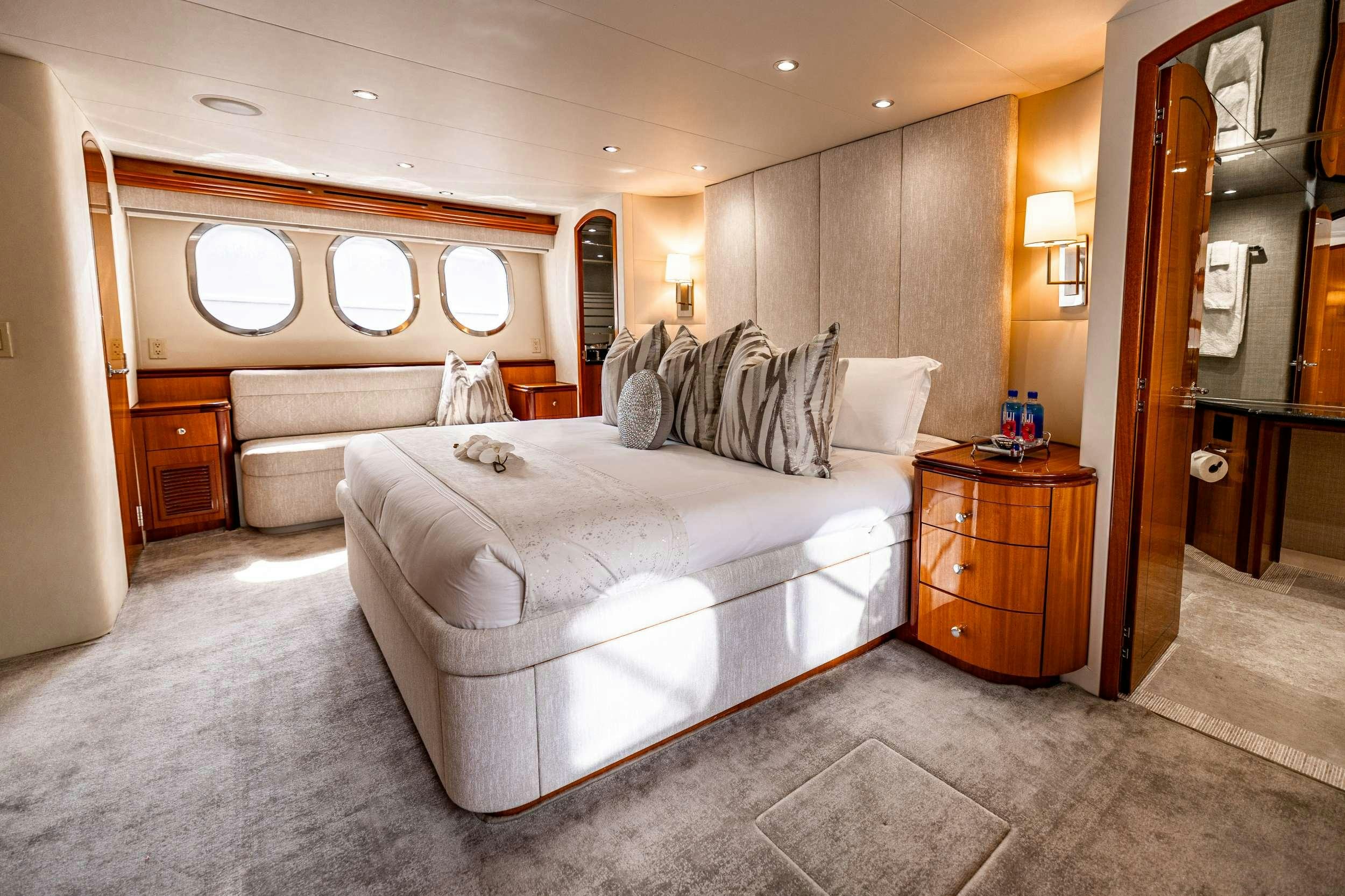 a large bedroom with a large bed aboard INDY Yacht for Charter