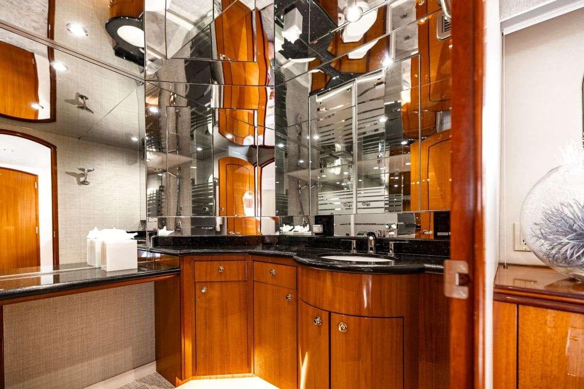 a kitchen with wooden cabinets aboard INDY Yacht for Charter