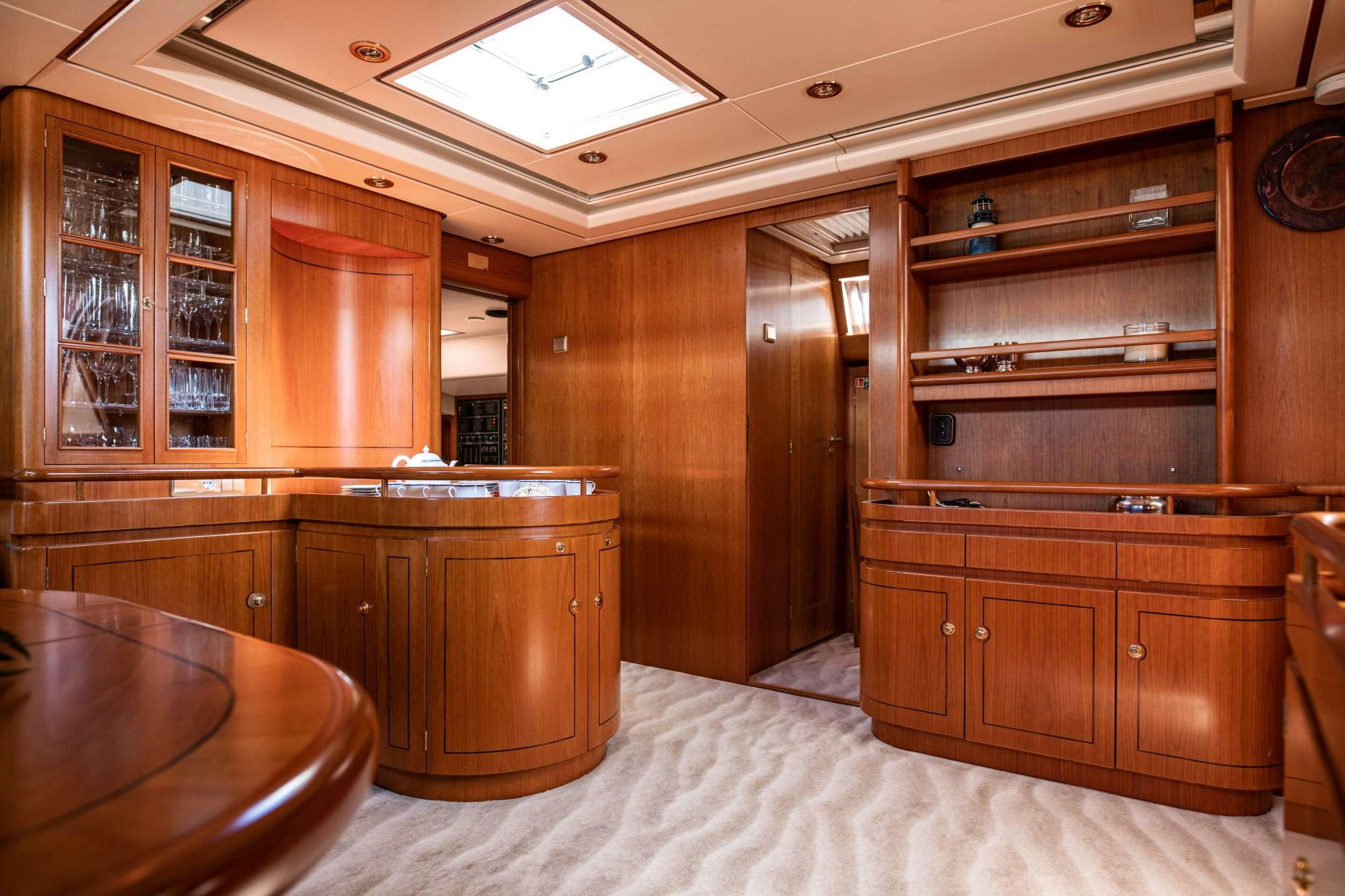 a bedroom with wooden cabinets aboard SCARENA Yacht for Charter