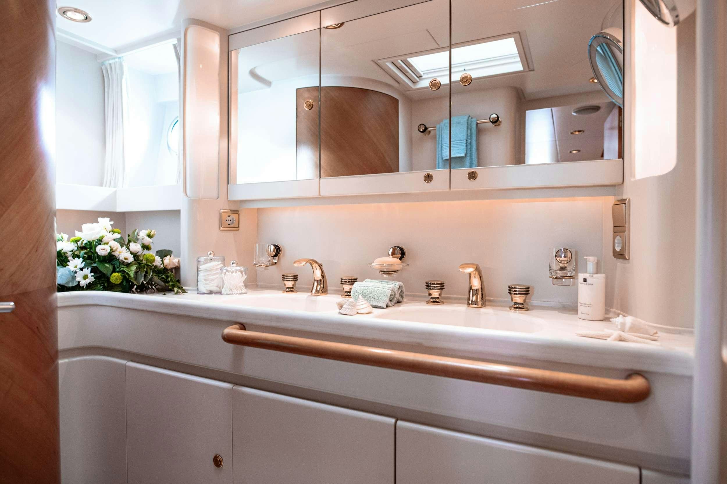 a bathroom with a large mirror aboard SCARENA Yacht for Charter