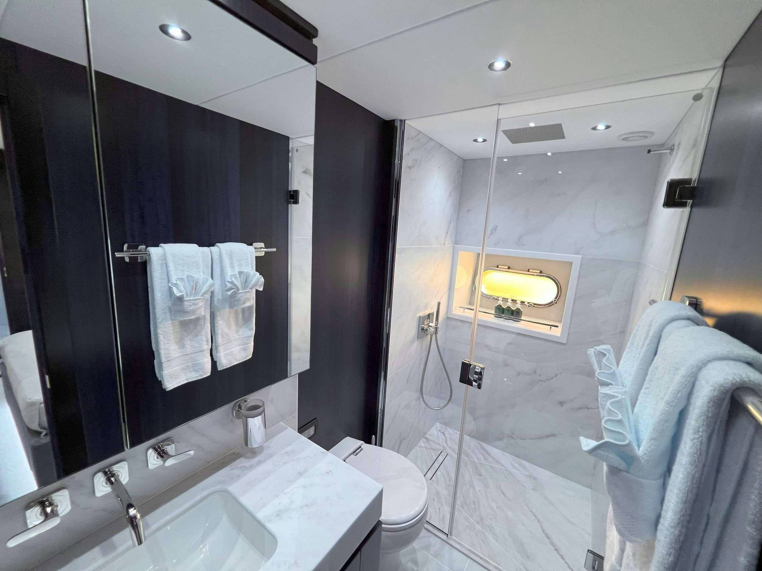 a bathroom with a large mirror aboard ACCIDENTAL SUCCESS II Yacht for Charter