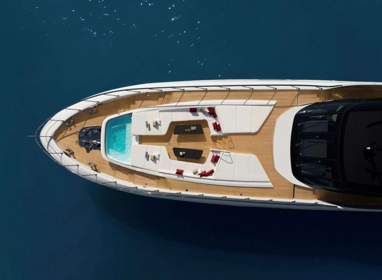 a white and black model of a ship on a blue surface aboard N1 Yacht for Charter