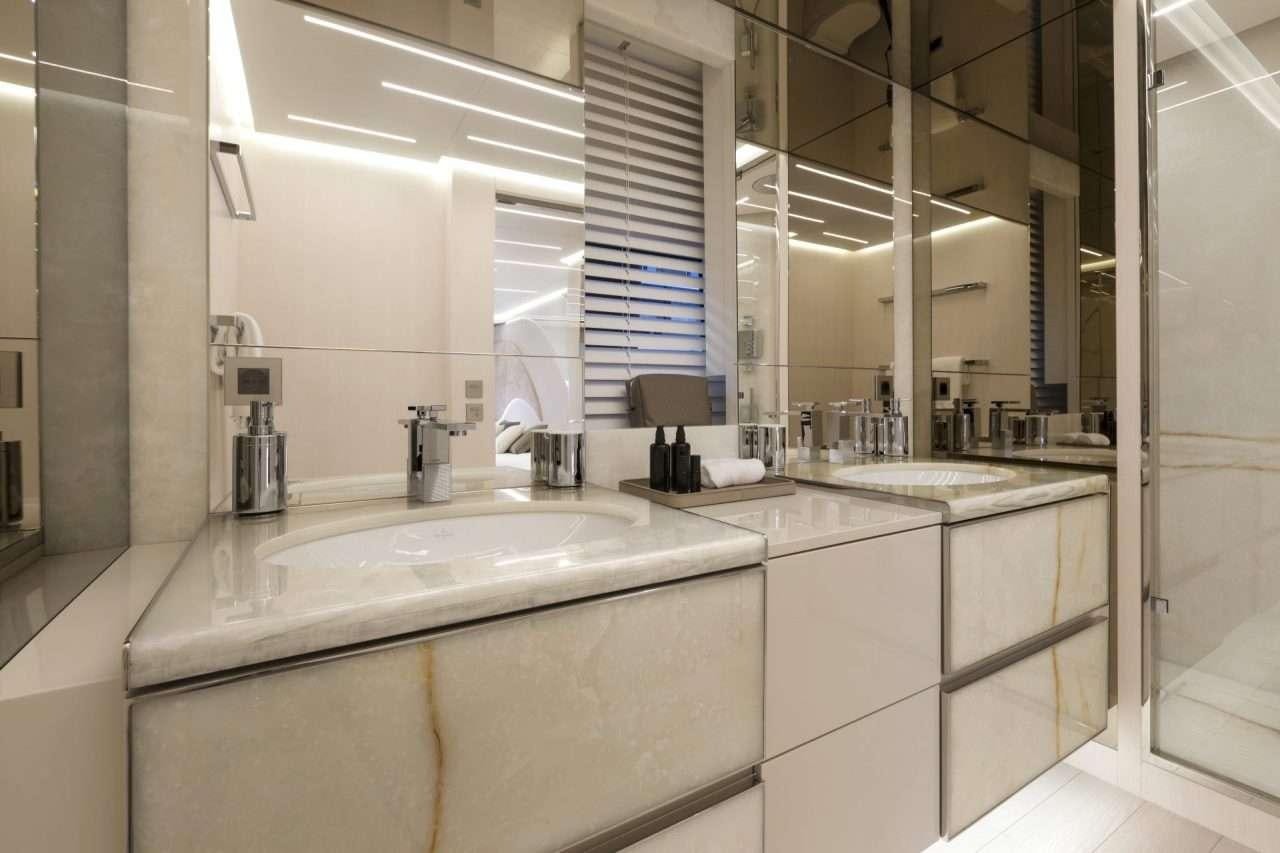 a bathroom with a sink and a mirror aboard N1 Yacht for Charter