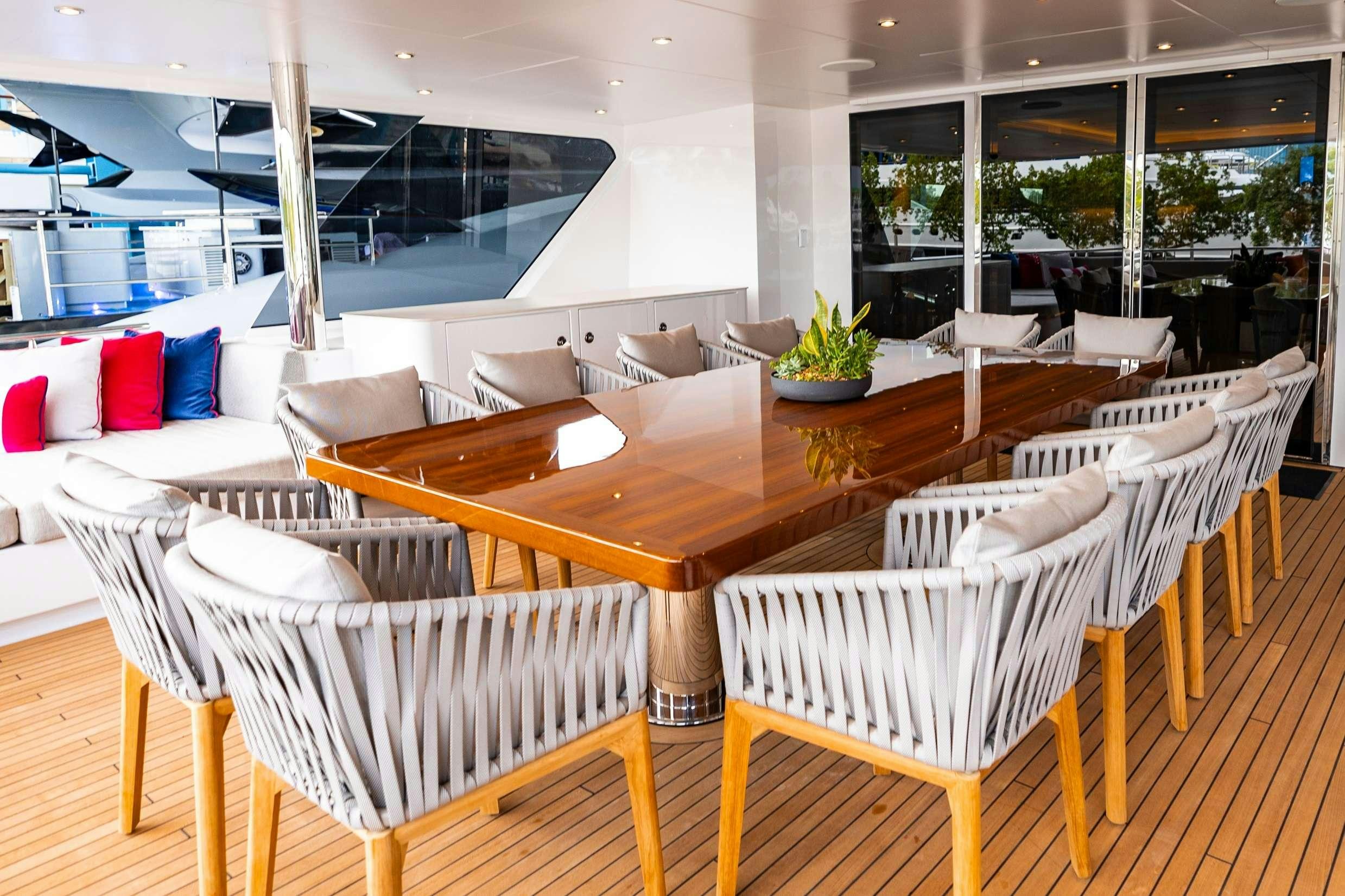 a room with tables and chairs aboard NO BAD IDEAS Yacht for Charter