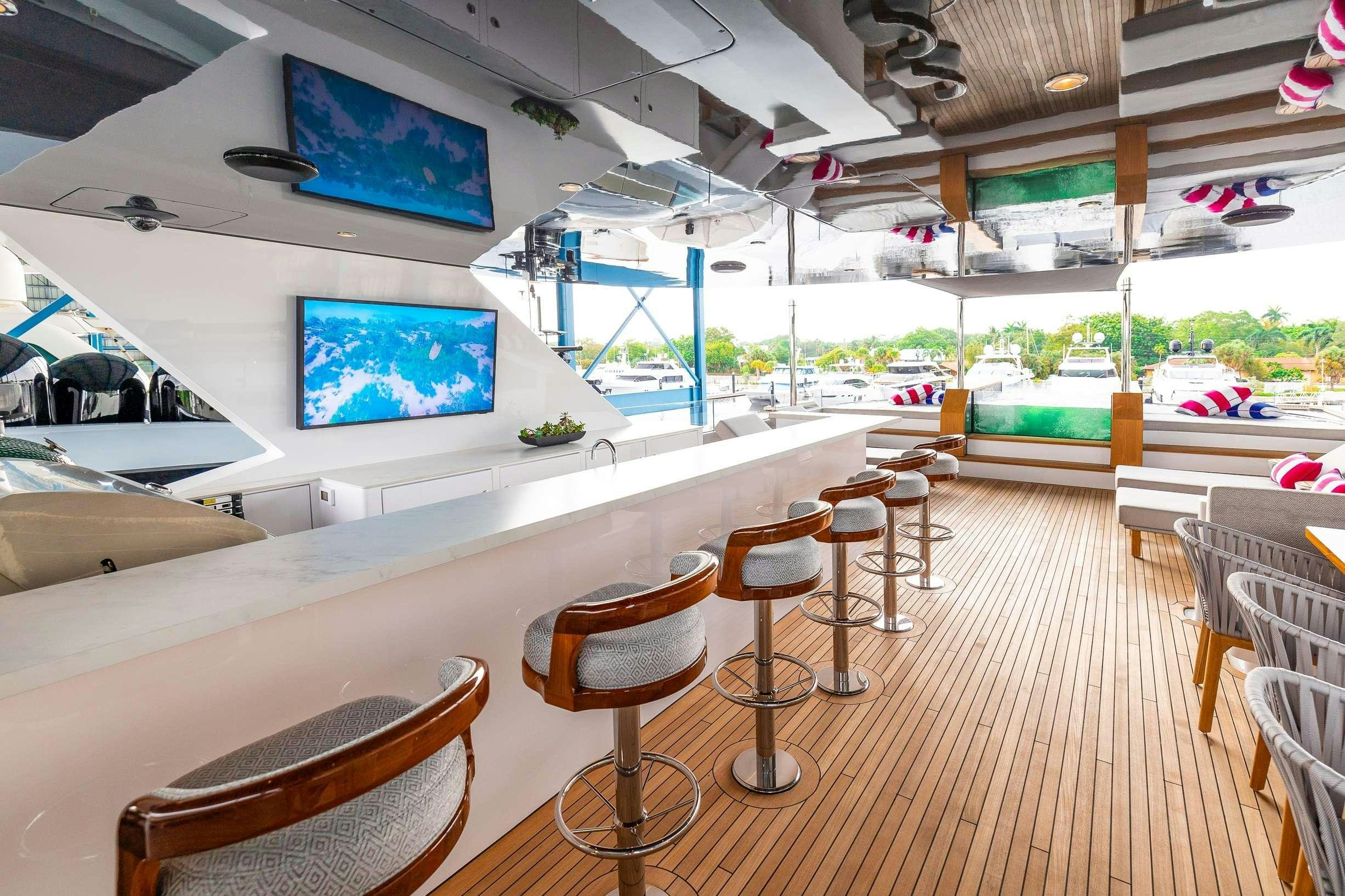 a room with tables and chairs aboard NO BAD IDEAS Yacht for Charter