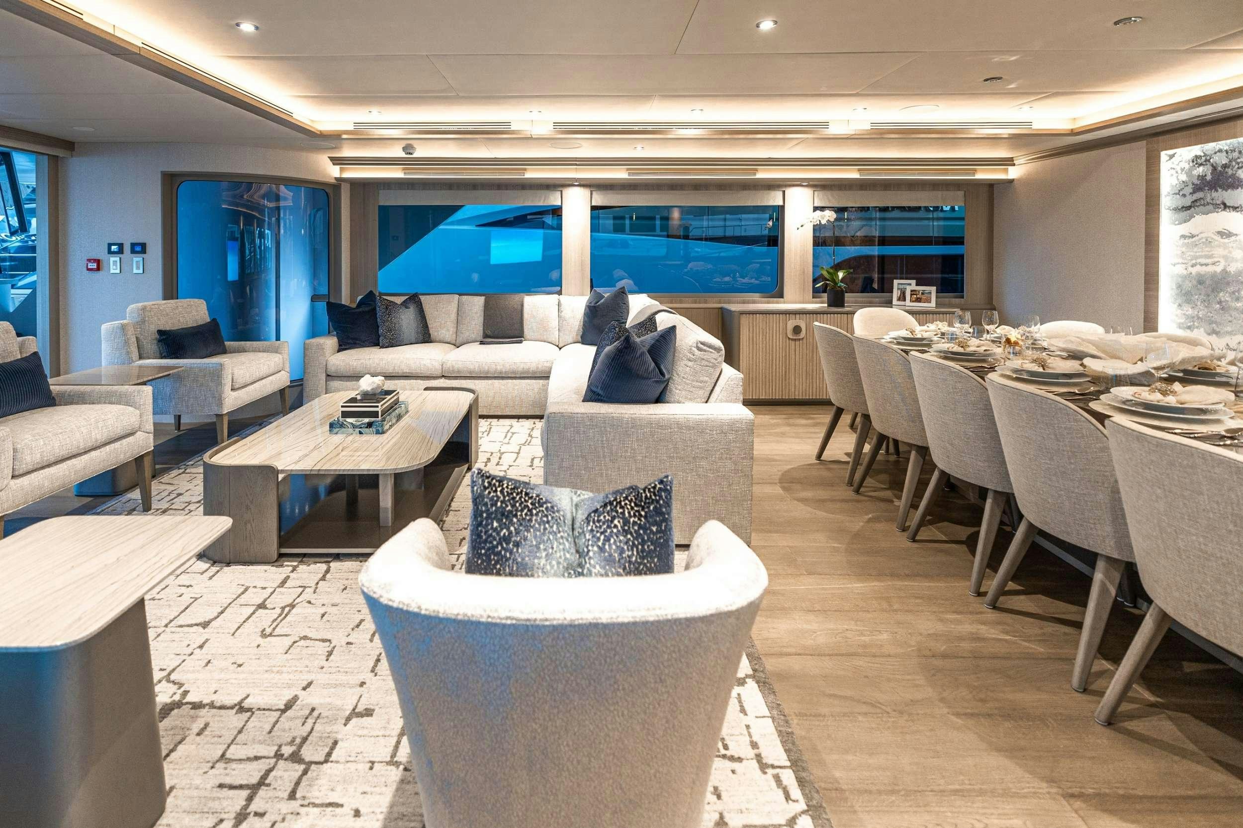a room with a couch and chairs aboard NO BAD IDEAS Yacht for Charter
