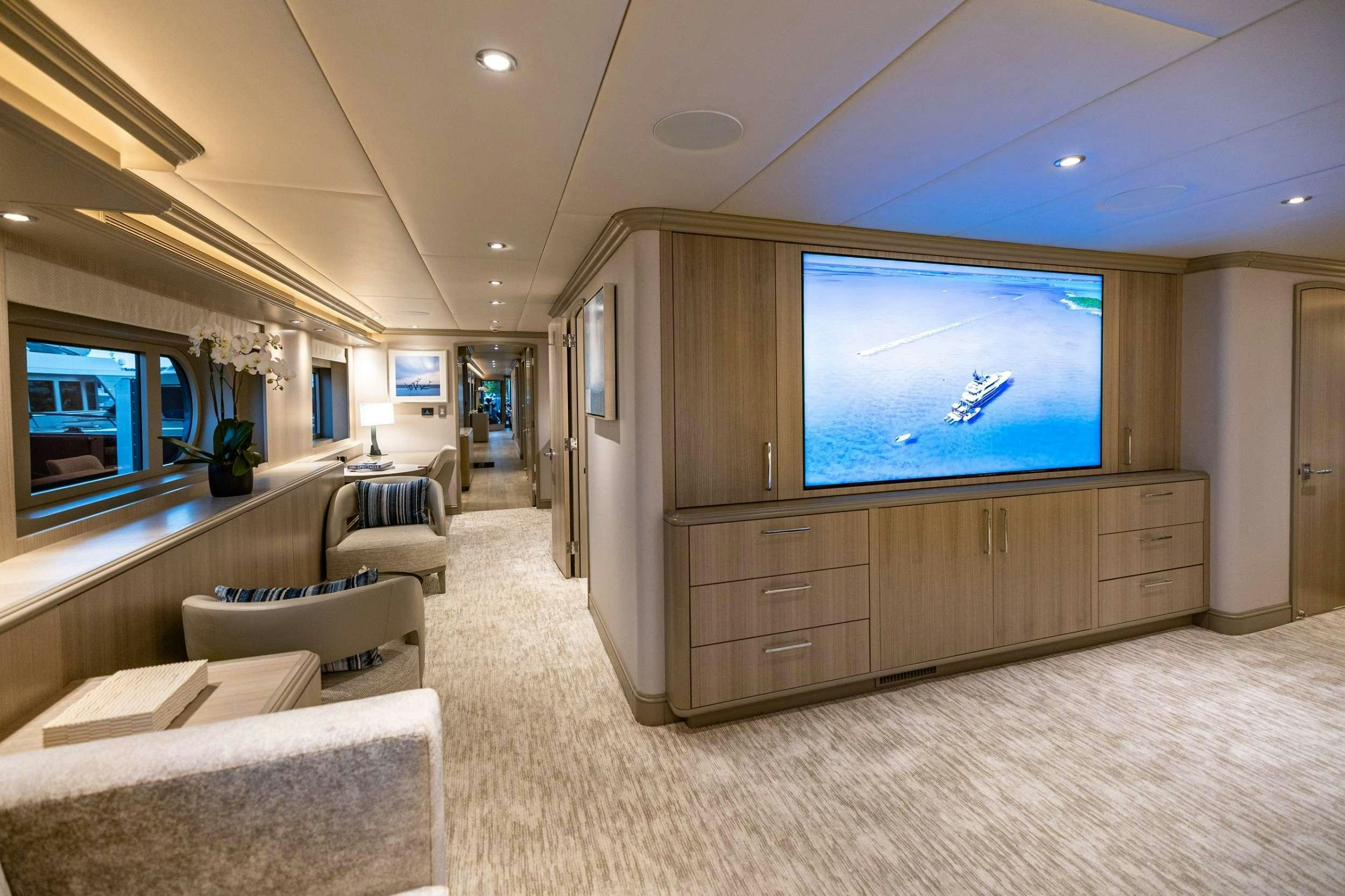 a large room with a large tv aboard NO BAD IDEAS Yacht for Charter
