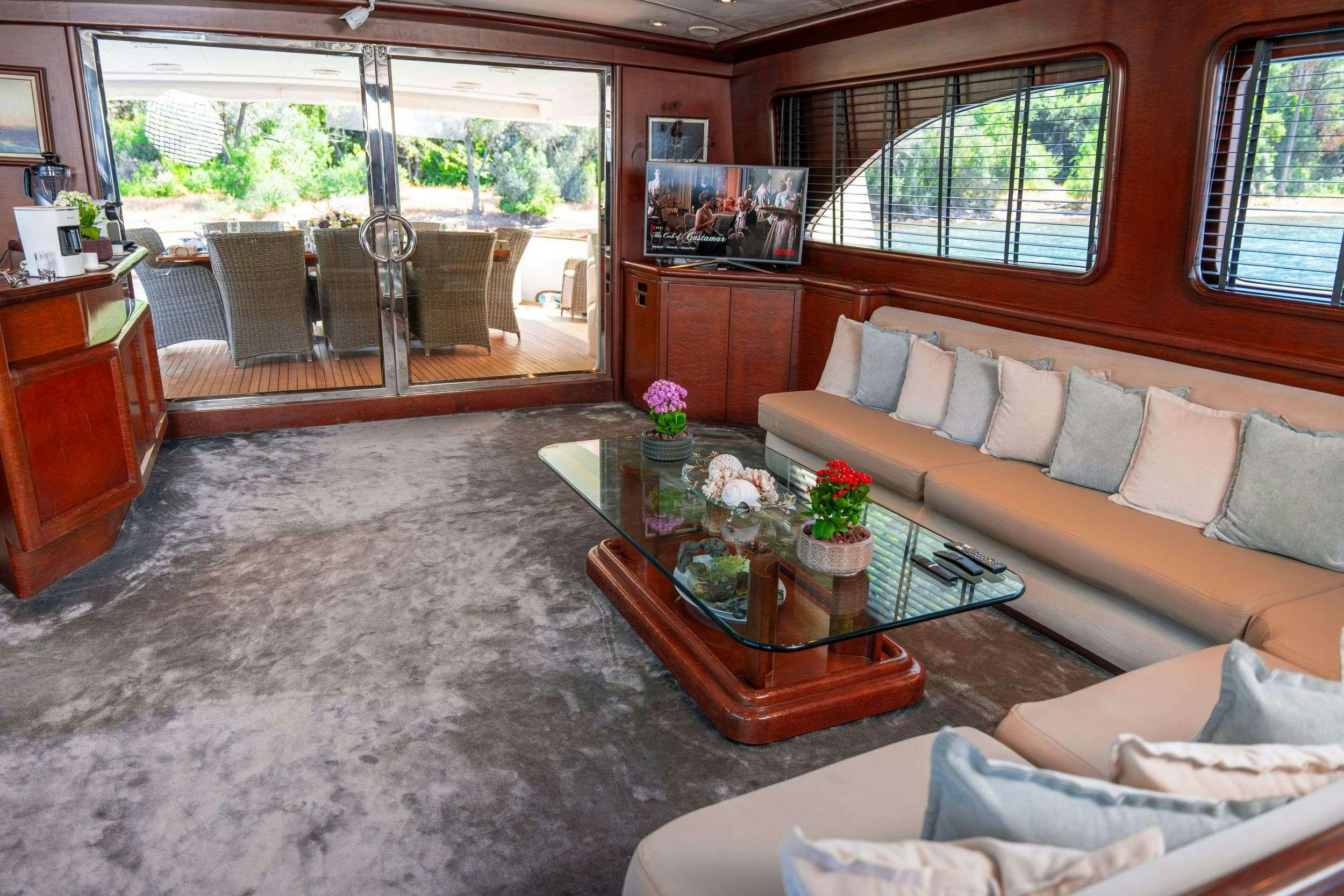 a living room with a couch and a coffee table aboard BLUES Yacht for Charter