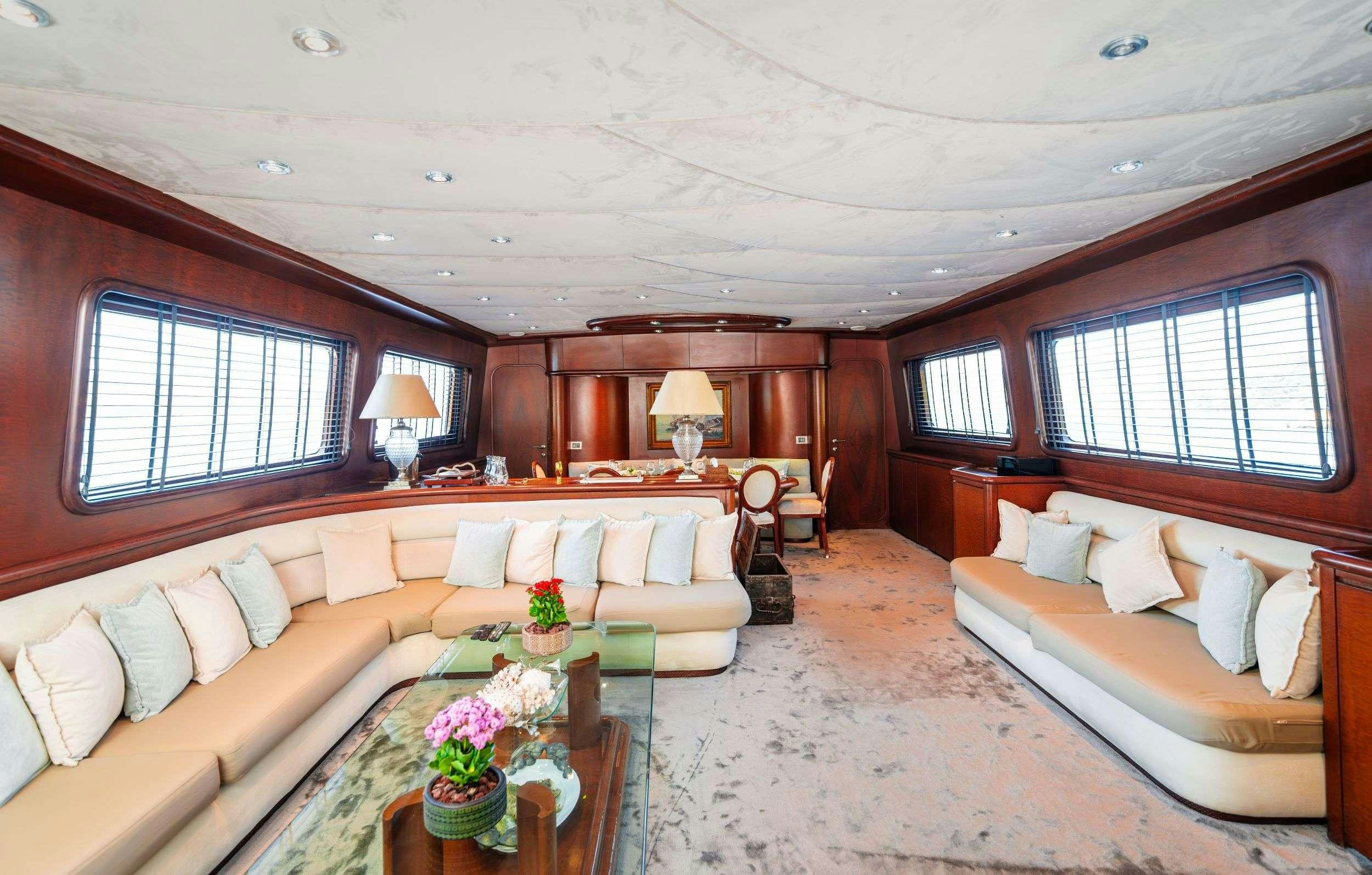 a living room with a couch and a table aboard BLUES Yacht for Charter