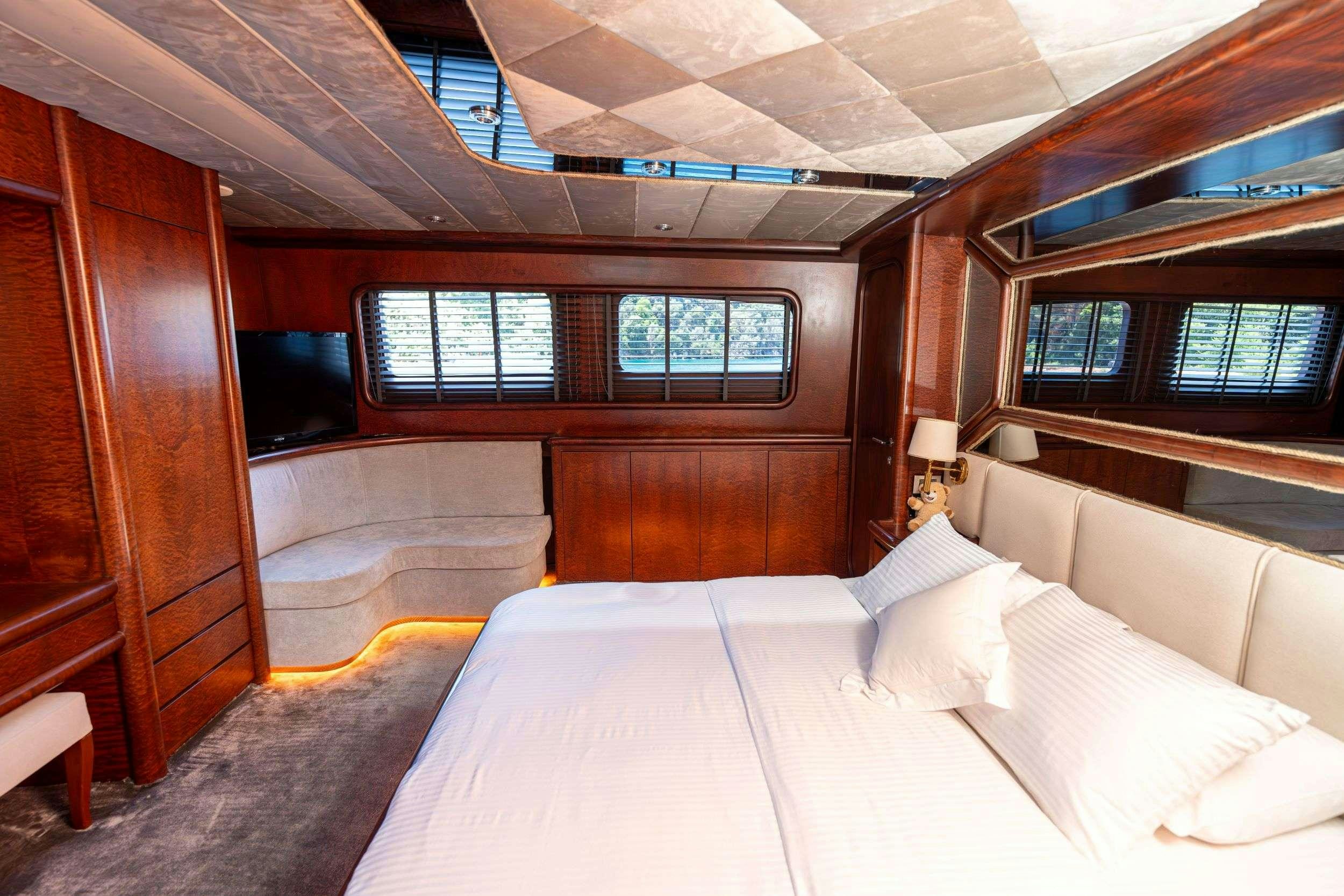 a room with a bed and a window aboard BLUES Yacht for Charter