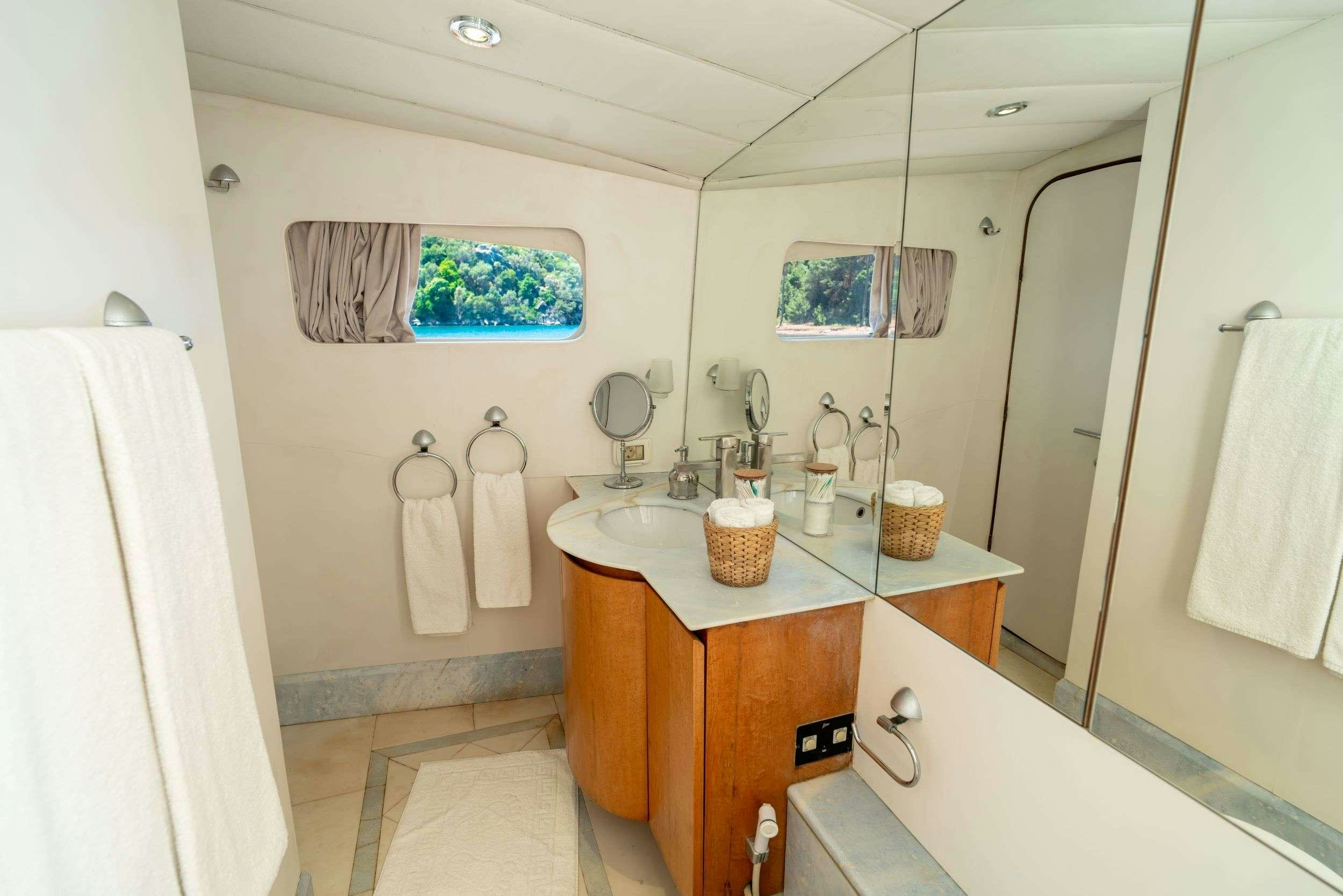a bathroom with a sink and a mirror aboard BLUES Yacht for Charter
