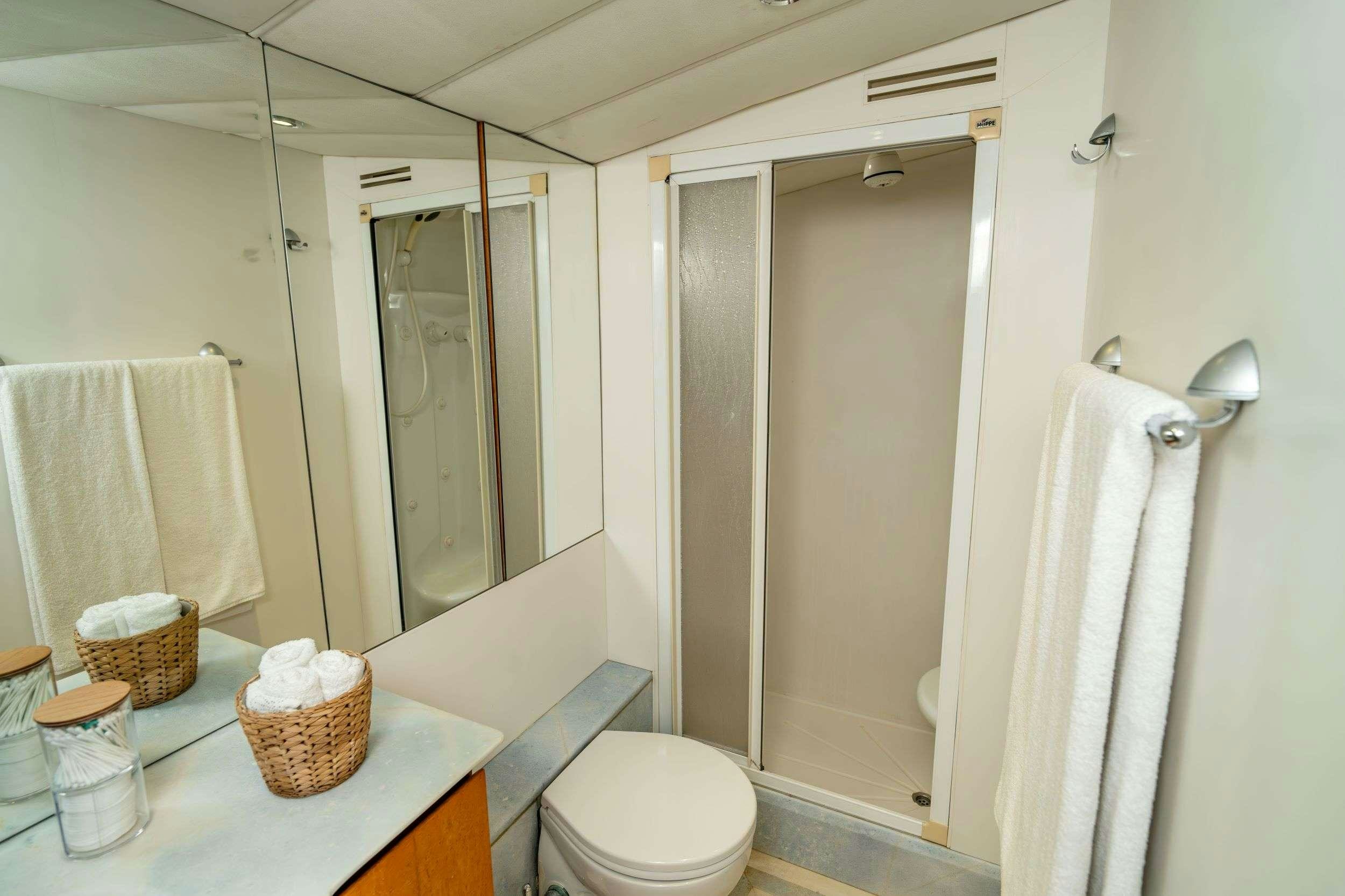 a bathroom with a shower and toilet aboard BLUES Yacht for Charter