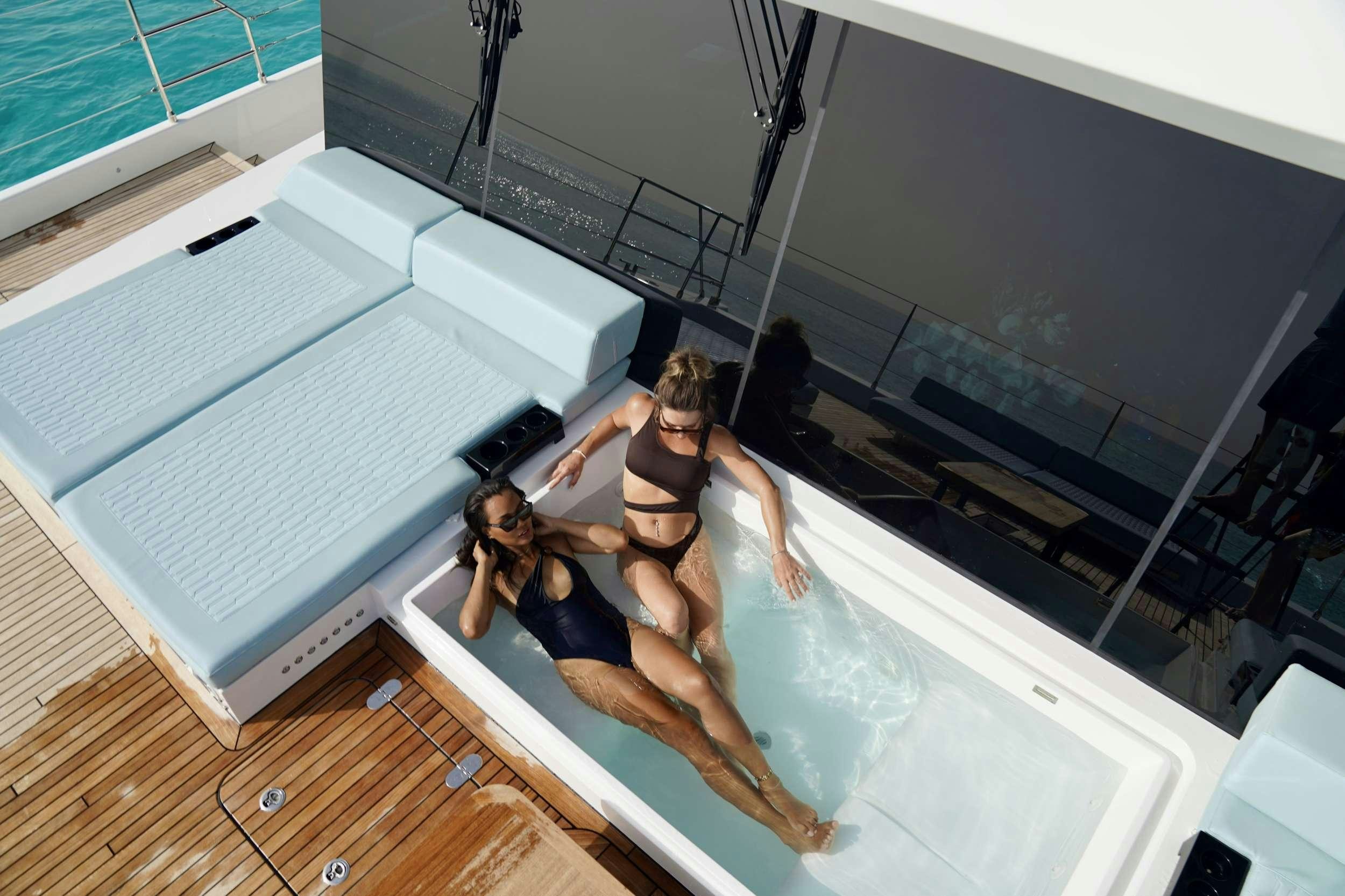 a couple of women posing for a picture on a staircase aboard MARIA THERESE Yacht for Charter