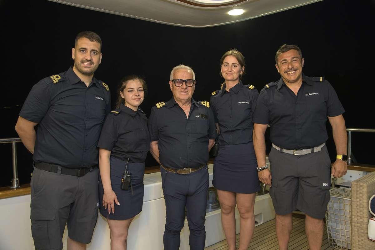 a group of people posing for a photo aboard ANNE MARIE Yacht for Charter