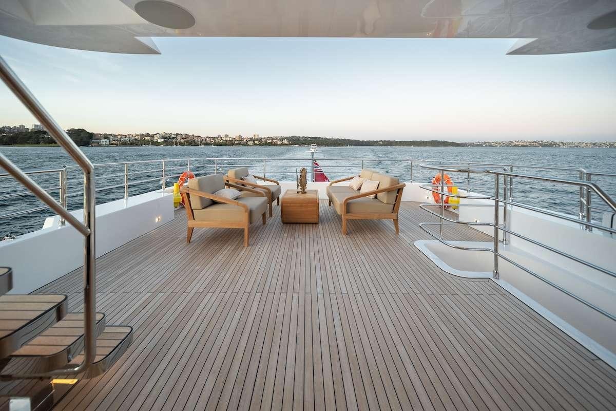 a deck with chairs and a body of water aboard BLUESTONE 1 Yacht for Charter