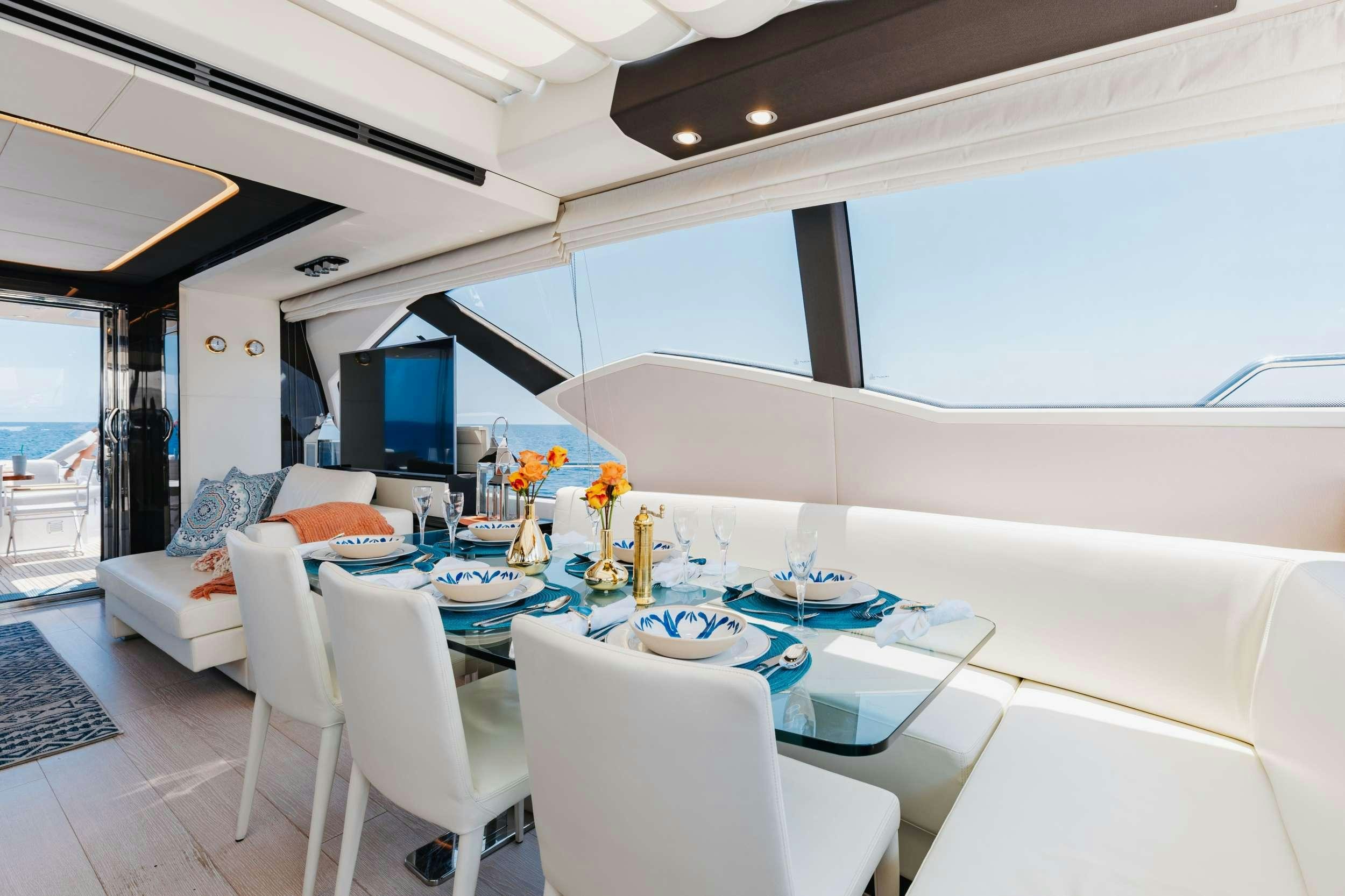 a dining room with a table and chairs aboard HIGH MAINTENANCE Yacht for Charter