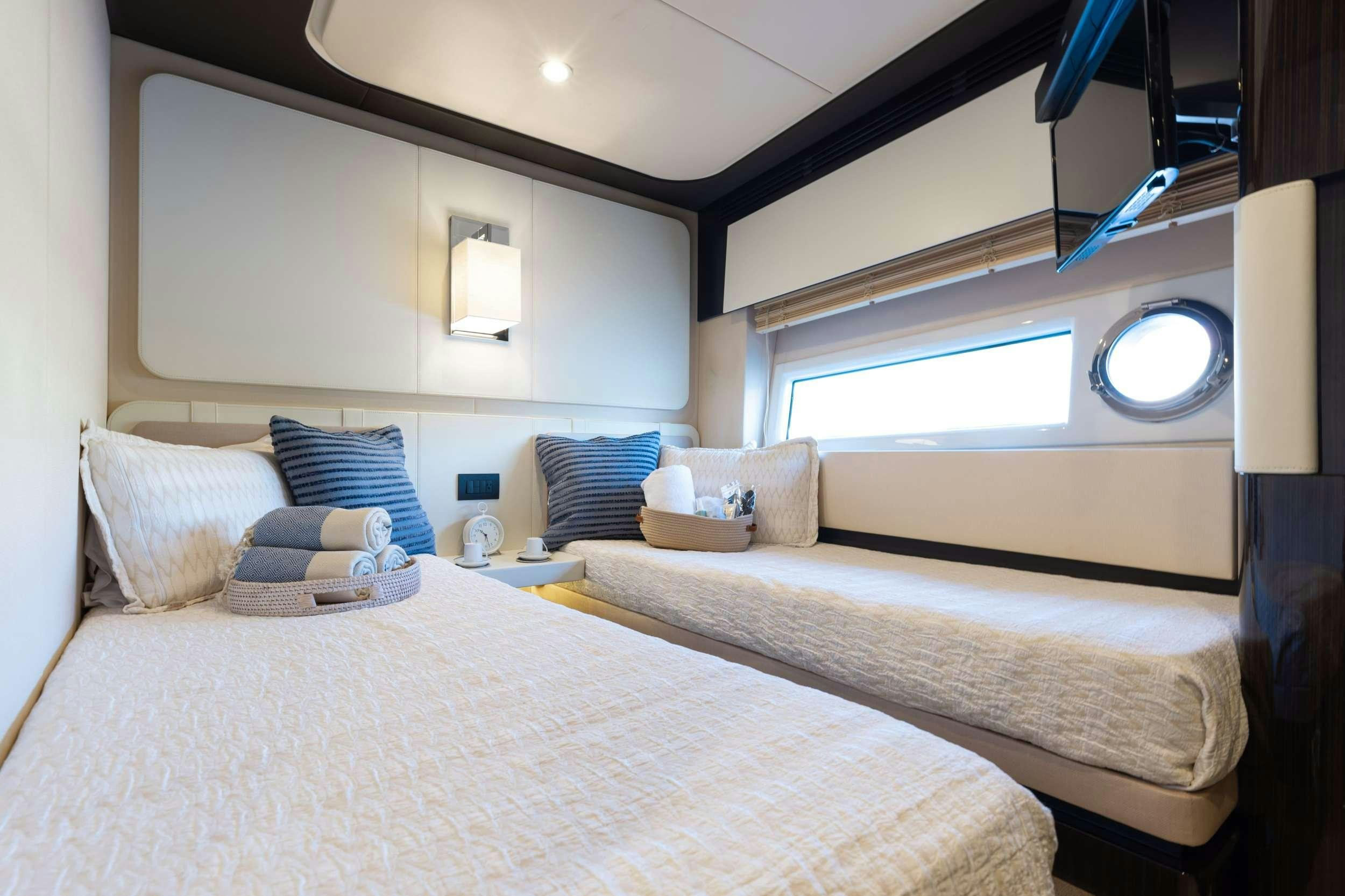 a room with a bed and a window aboard HIGH MAINTENANCE Yacht for Charter