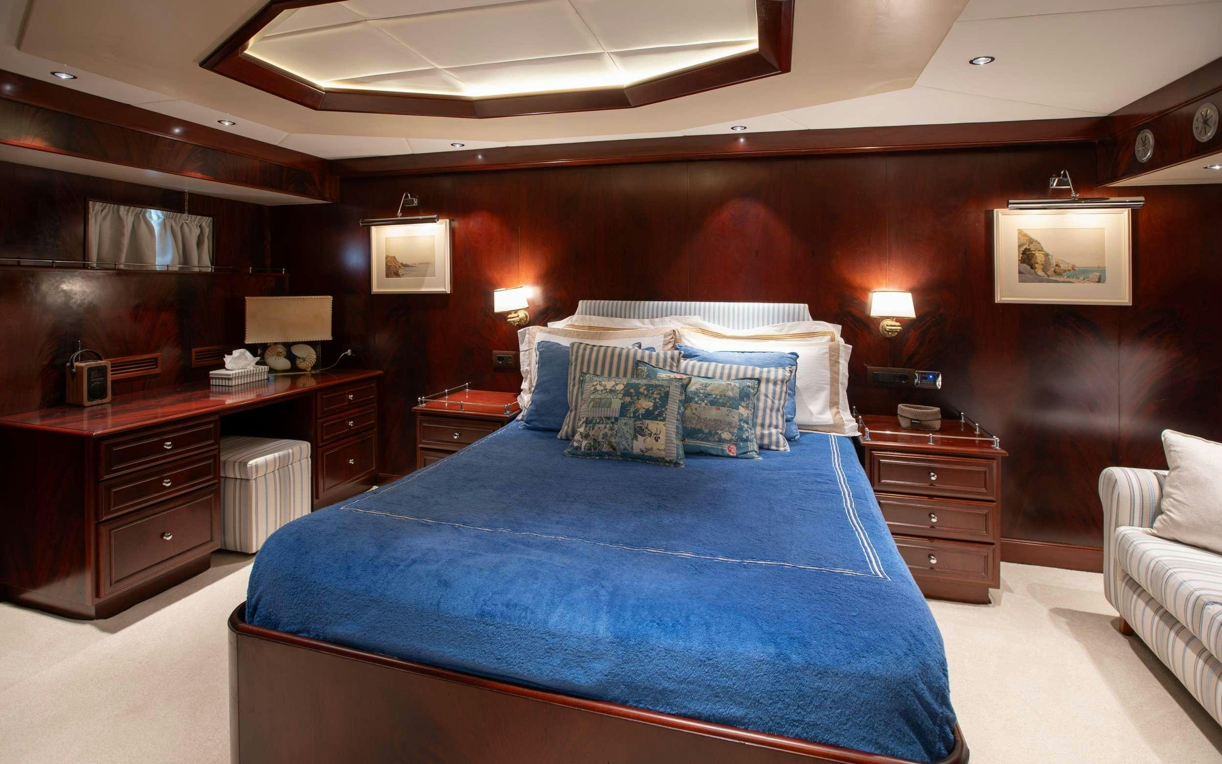 a bed in a room aboard LIBERTY OF LONDON Yacht for Charter