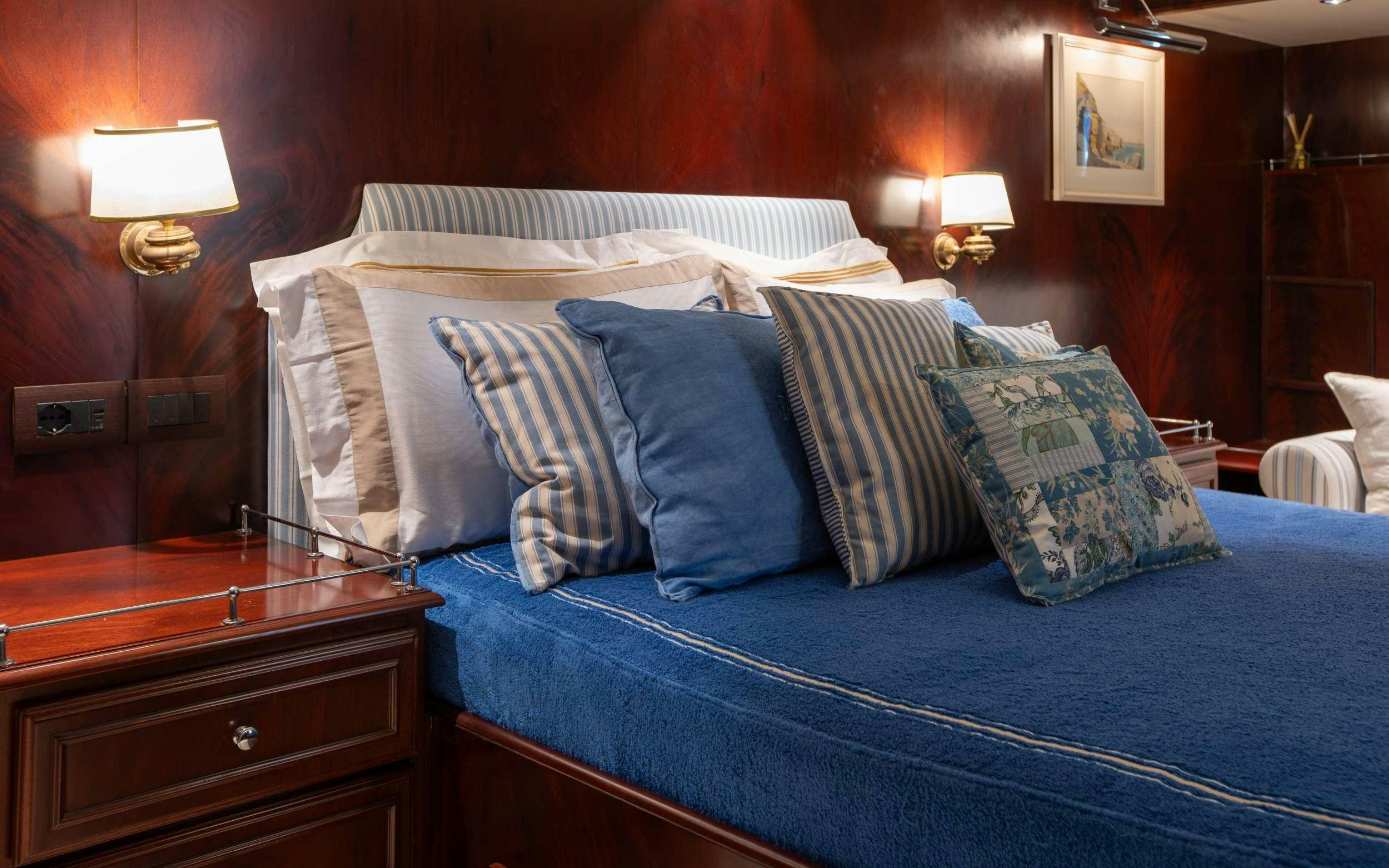 a bed with pillows aboard LIBERTY OF LONDON Yacht for Charter
