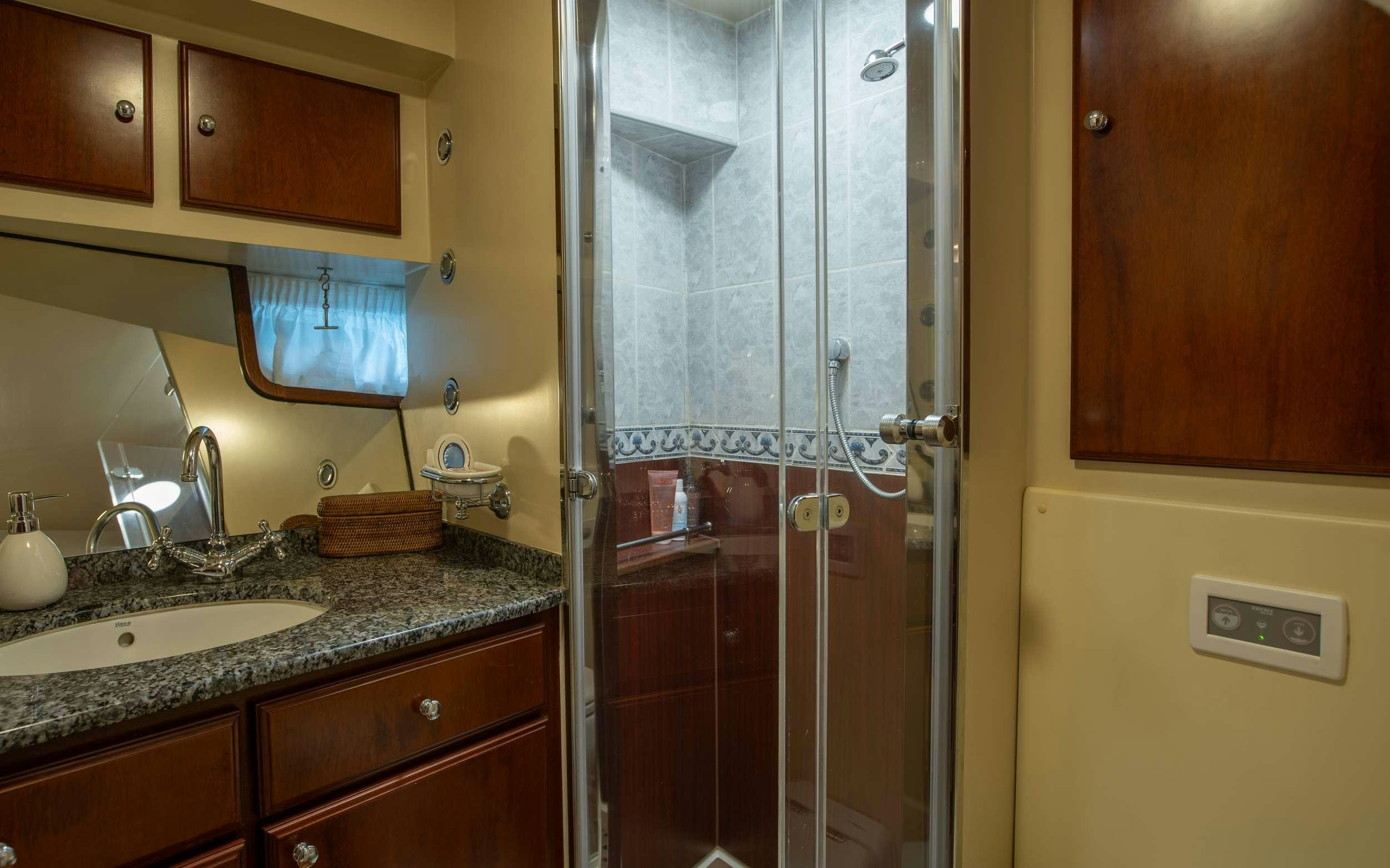 a bathroom with a glass shower aboard LIBERTY OF LONDON Yacht for Charter