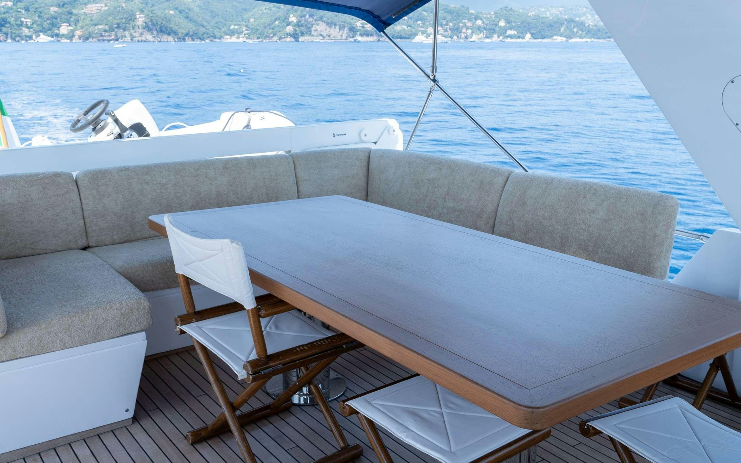 a table and chairs on a boat aboard LIBERTY OF LONDON Yacht for Charter