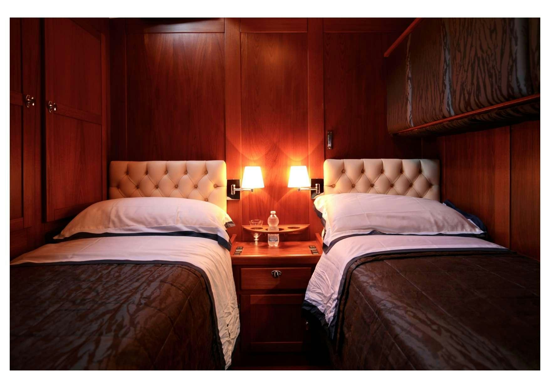 a couple of beds in a room aboard MARELLA Yacht for Charter