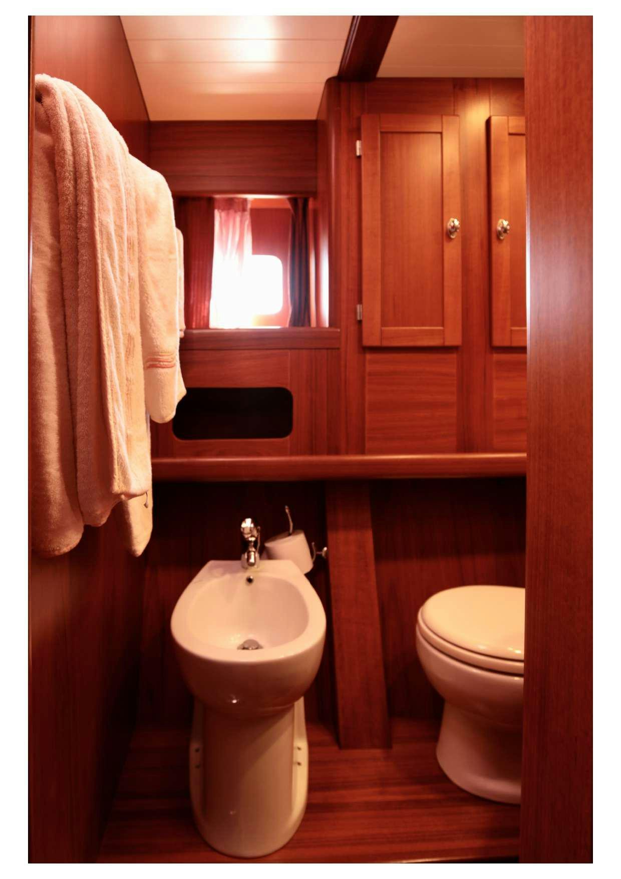 a bathroom with a sink and toilet aboard MARELLA Yacht for Charter