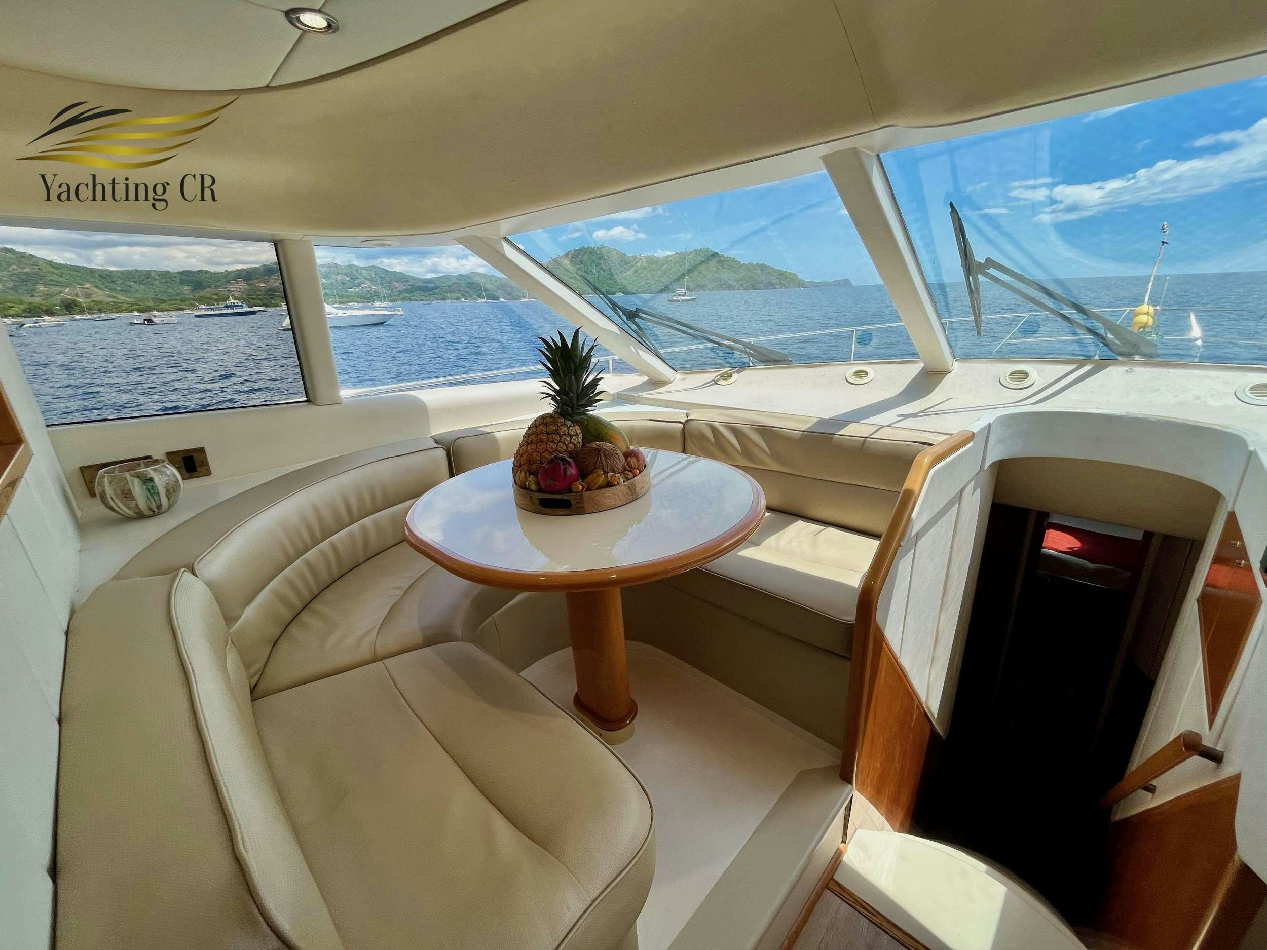 a room with a table and chairs aboard MORENA I Yacht for Charter
