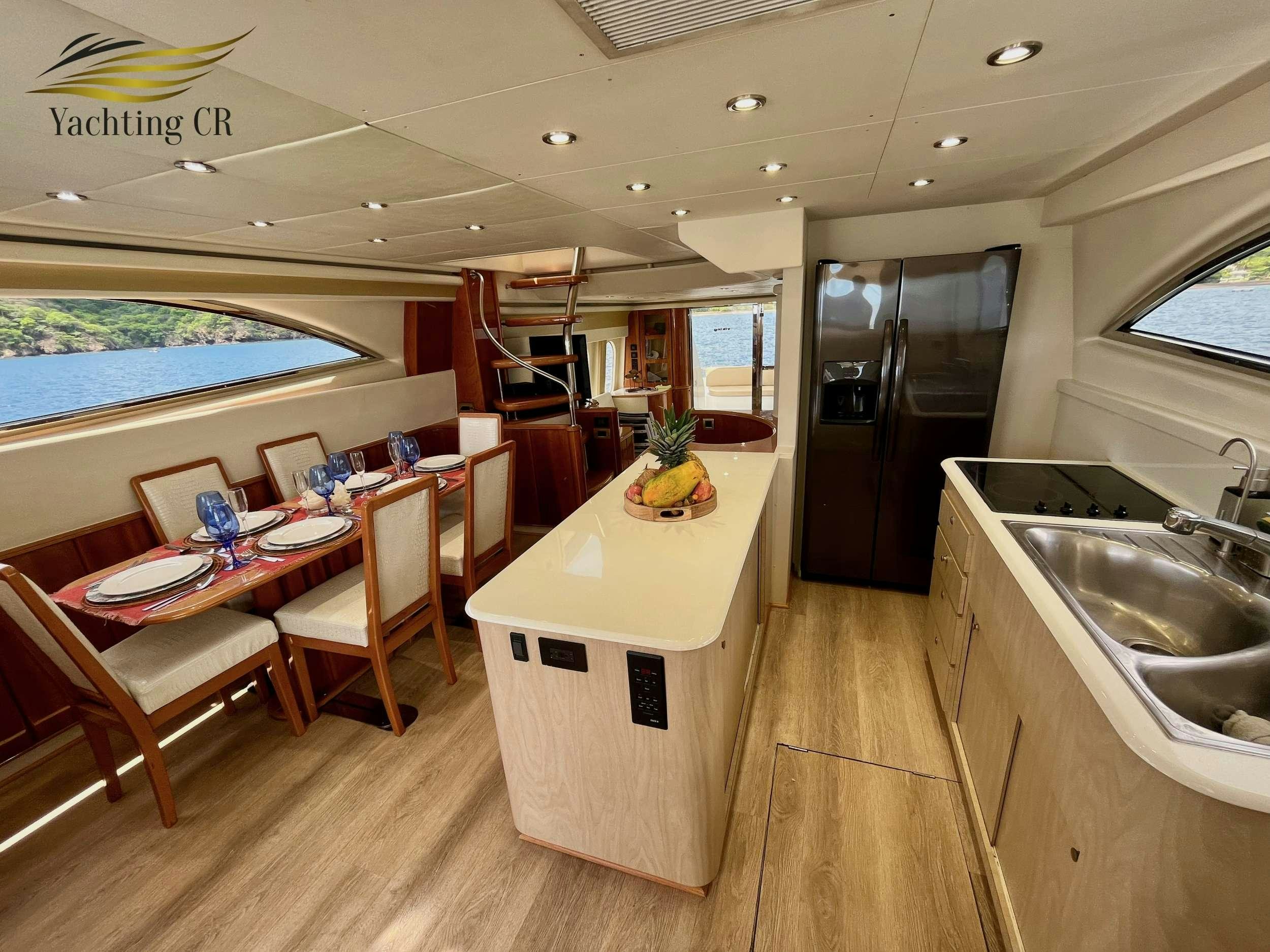 a kitchen with a table and chairs aboard MORENA I Yacht for Charter