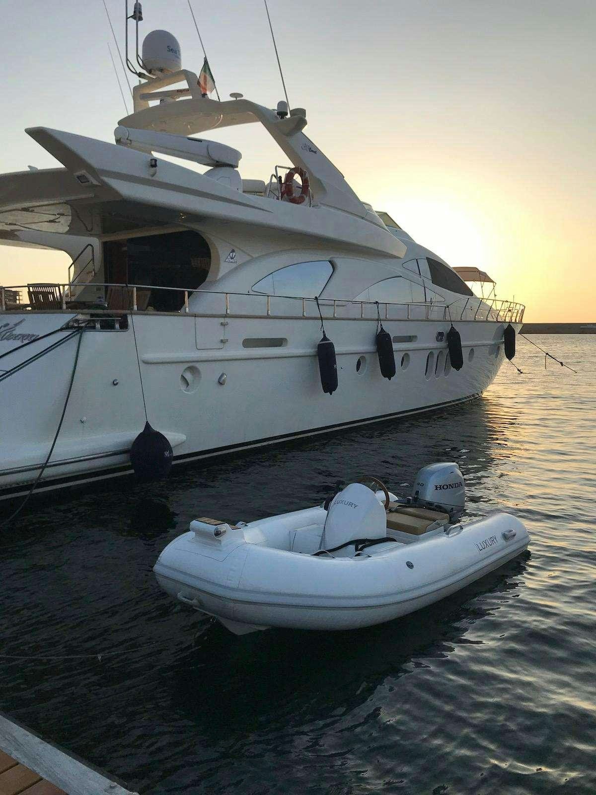 a white yacht docked at a dock aboard MINERVA Yacht for Charter