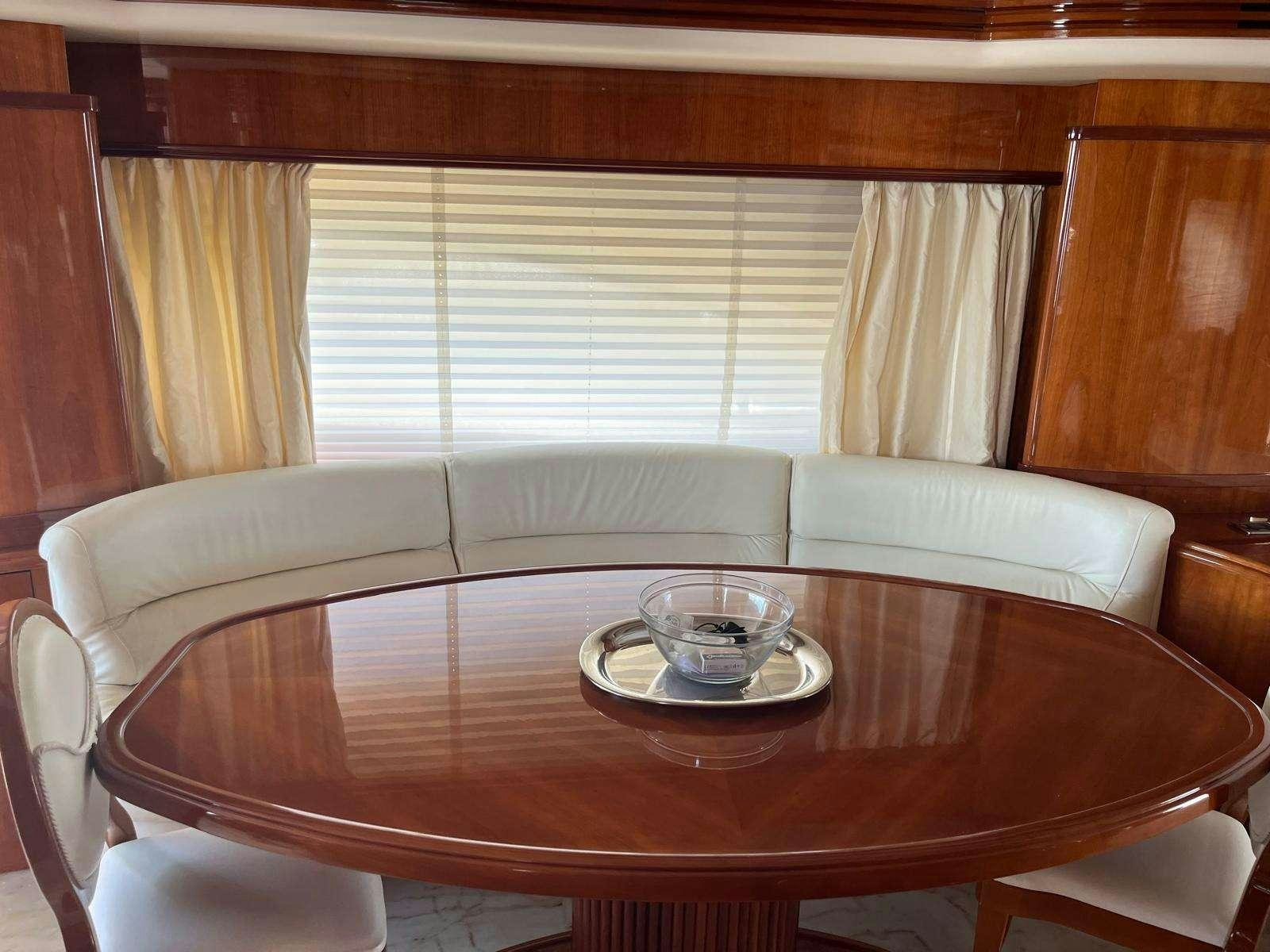a table with a glass on it aboard MINERVA Yacht for Charter