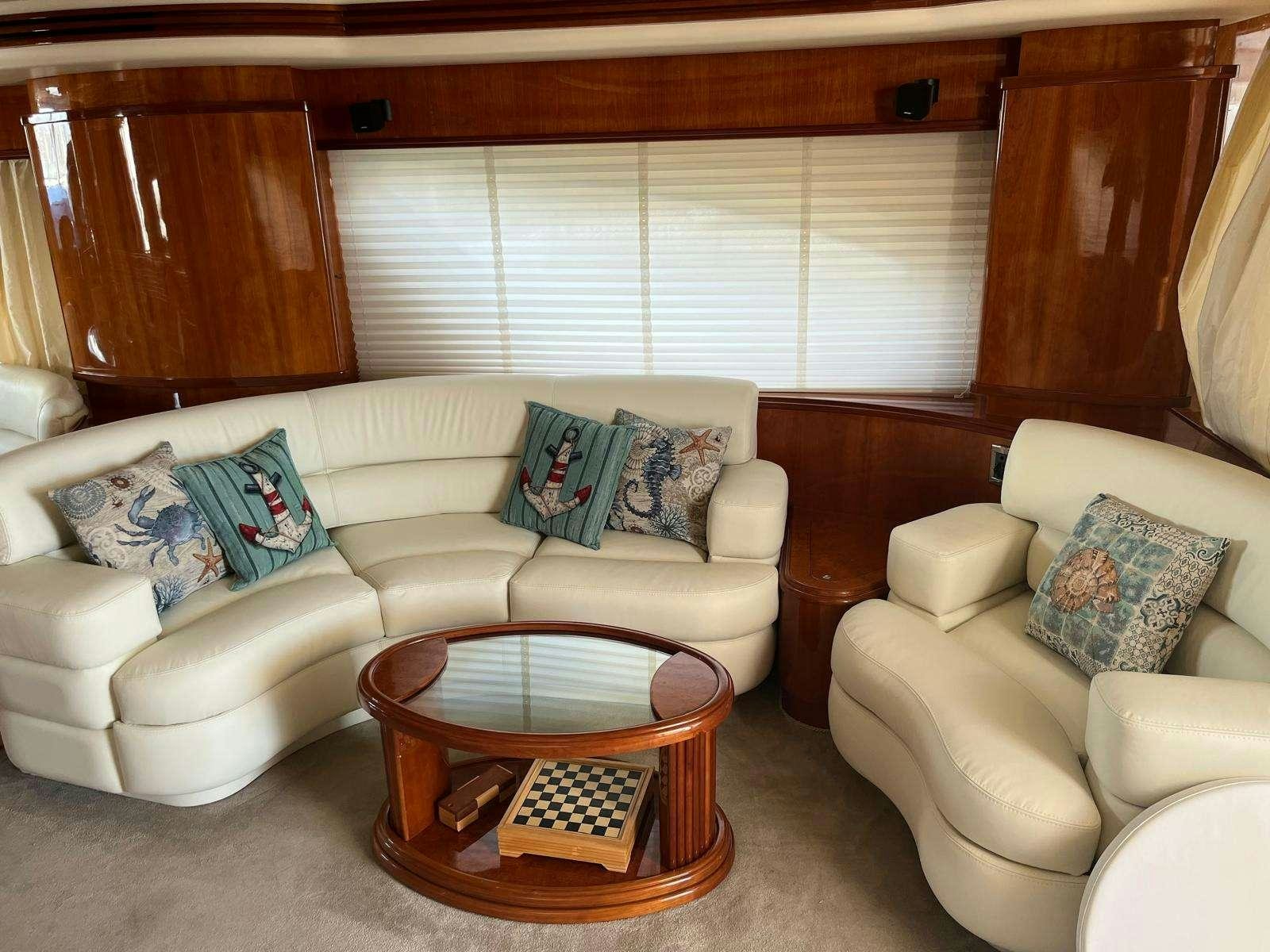 a living room with a couch and a coffee table aboard MINERVA Yacht for Charter