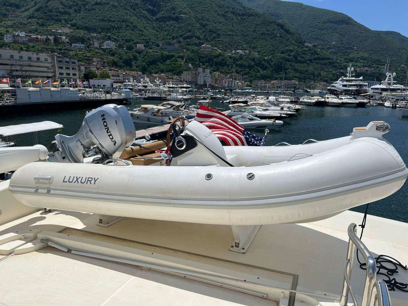 a boat with a flag on the front aboard MINERVA Yacht for Charter