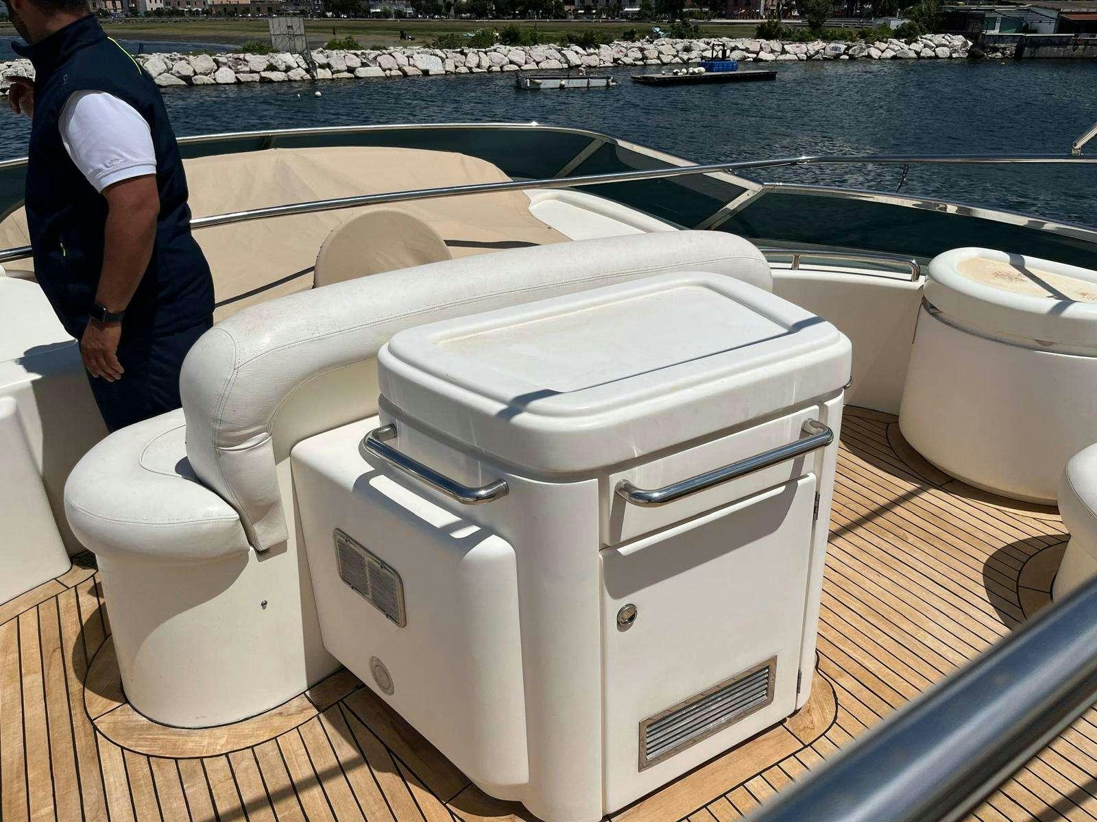 a person standing next to a white toilet aboard MINERVA Yacht for Charter