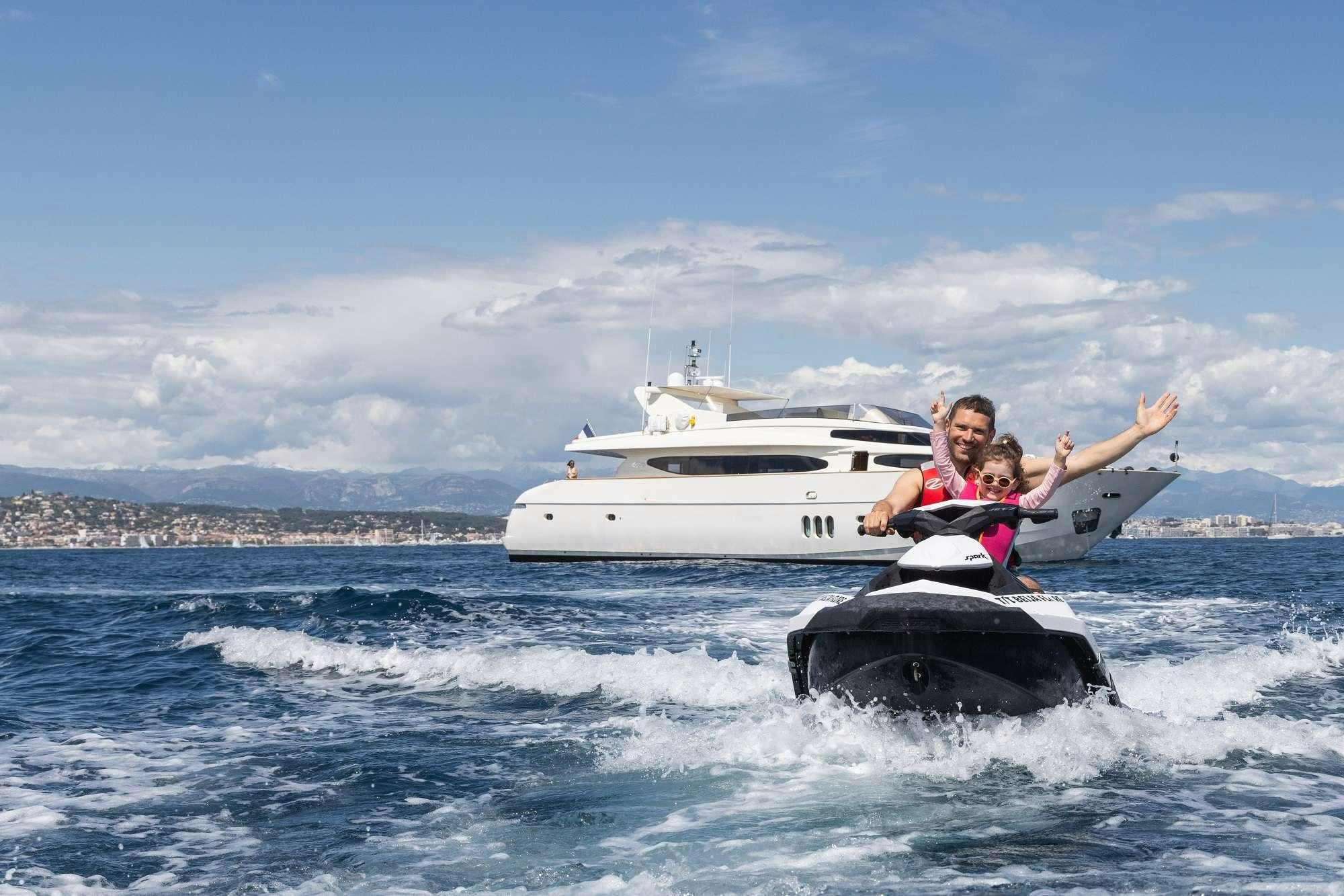 a couple of people on a speedboat in the water aboard BEIJA FLORE Yacht for Charter