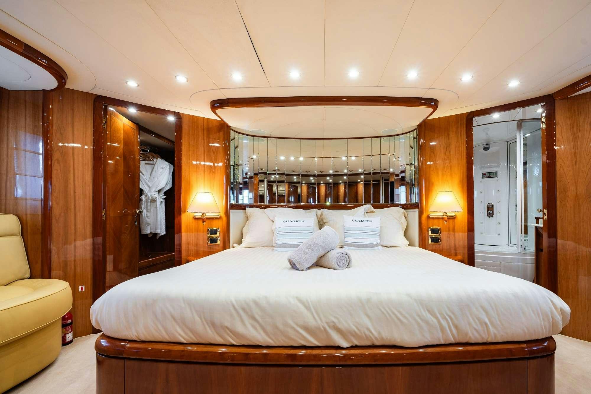 a bed with a mirror above it aboard BEIJA FLORE Yacht for Charter