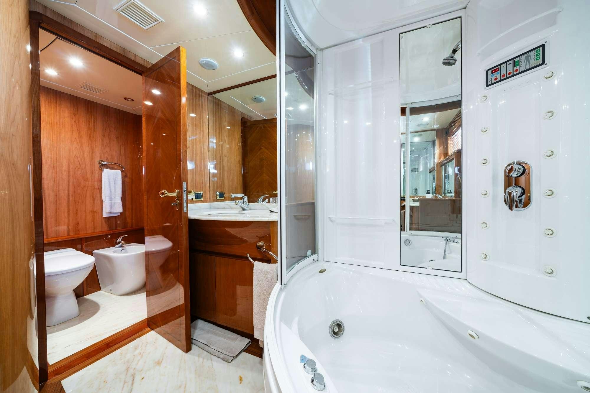 a bathroom with a tub sink and toilet aboard BEIJA FLORE Yacht for Charter