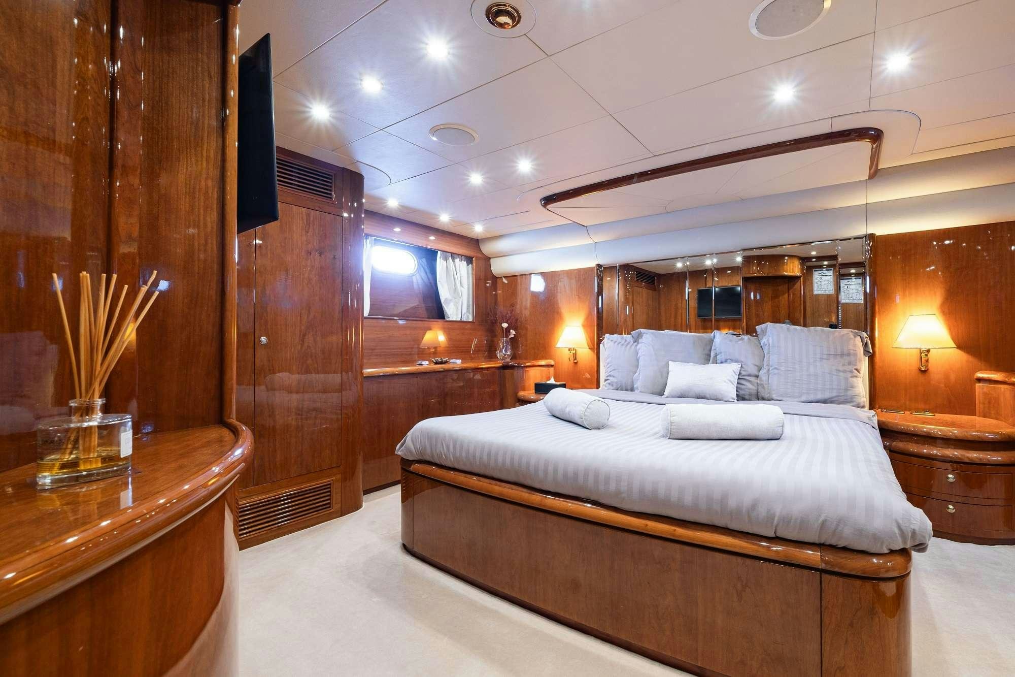 a room with a bed and a desk aboard BEIJA FLORE Yacht for Charter