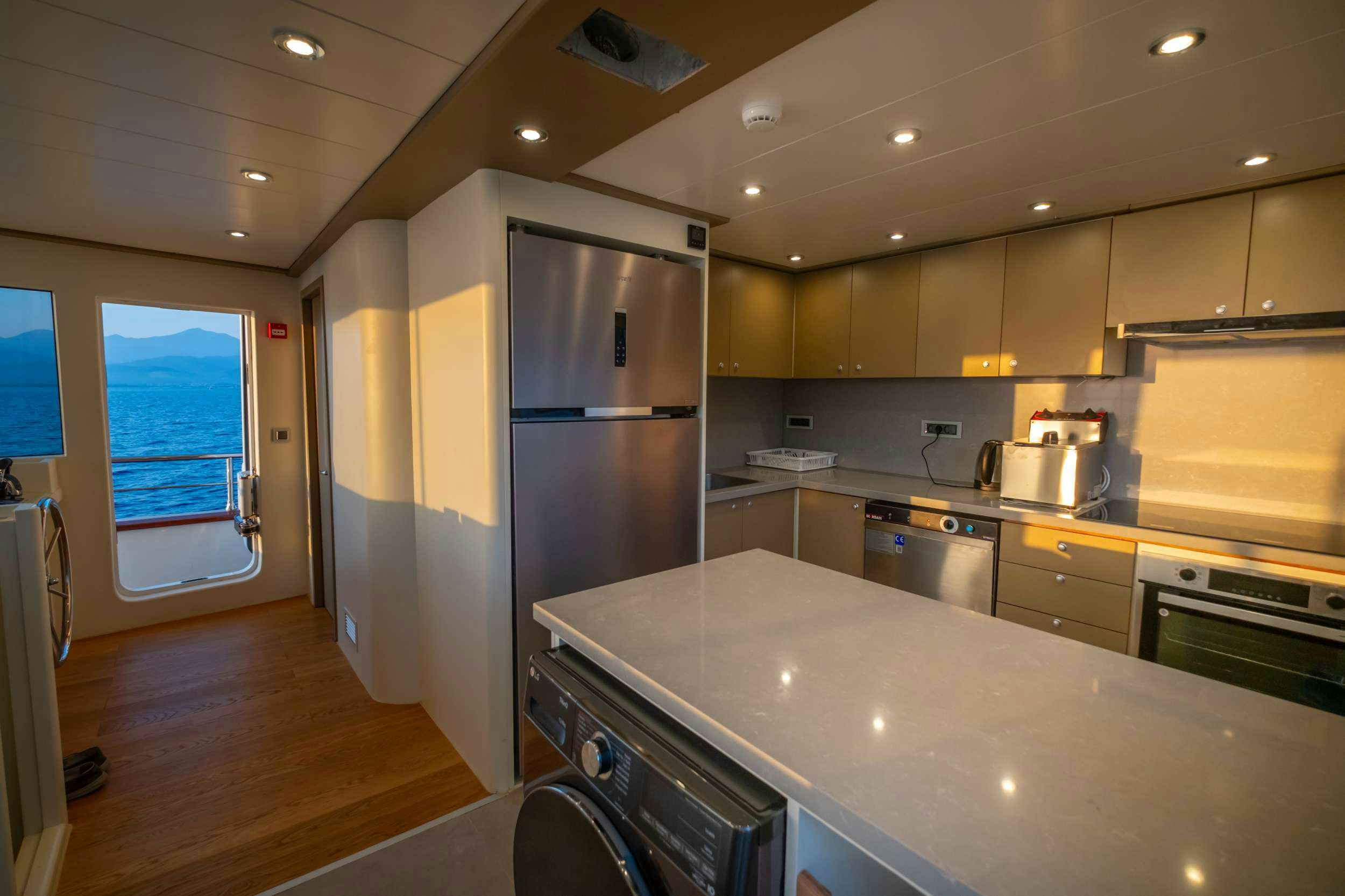 a kitchen with a refrigerator and stove aboard 88 YACHT Yacht for Charter