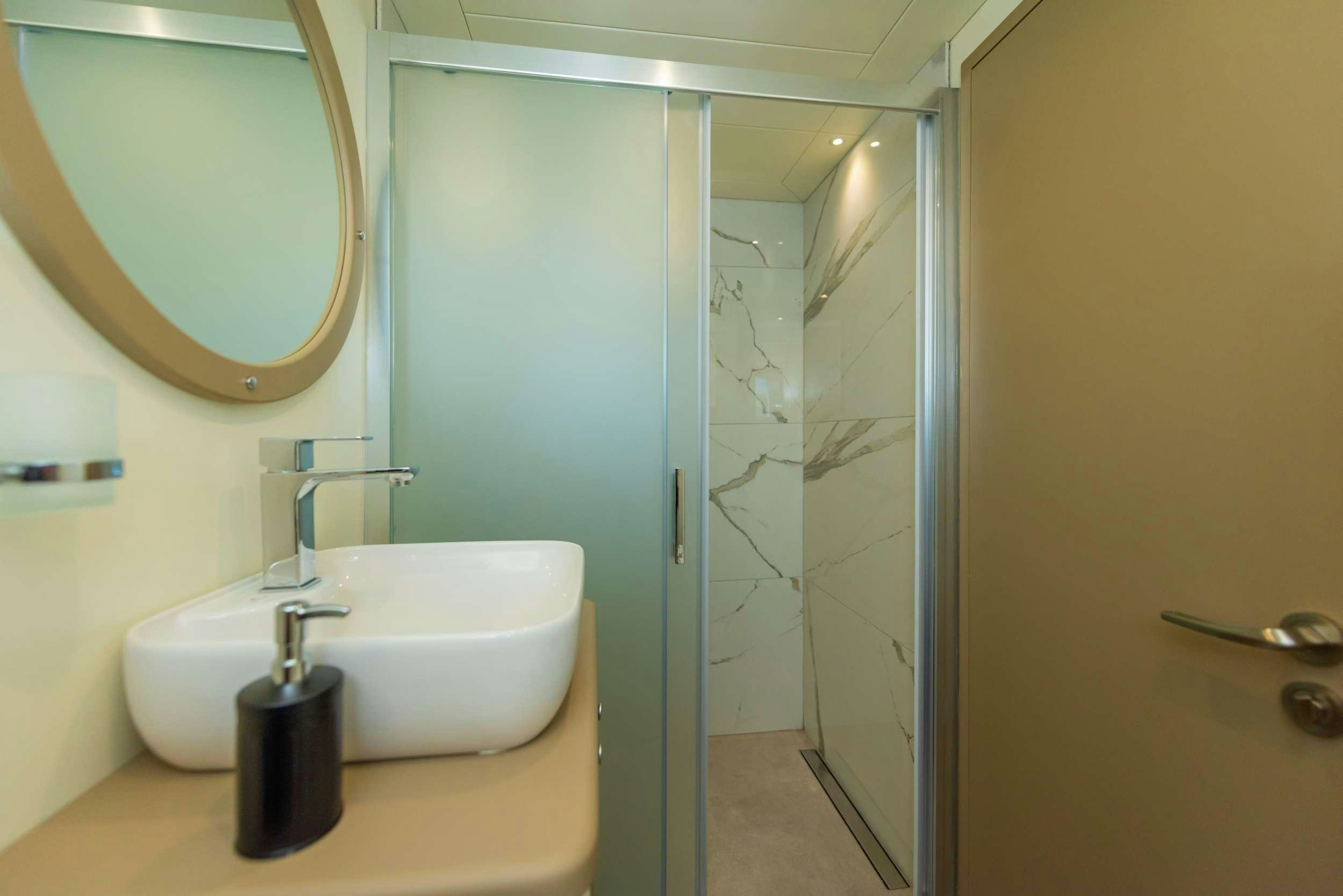 a bathroom with a sink and a mirror aboard 88 YACHT Yacht for Charter