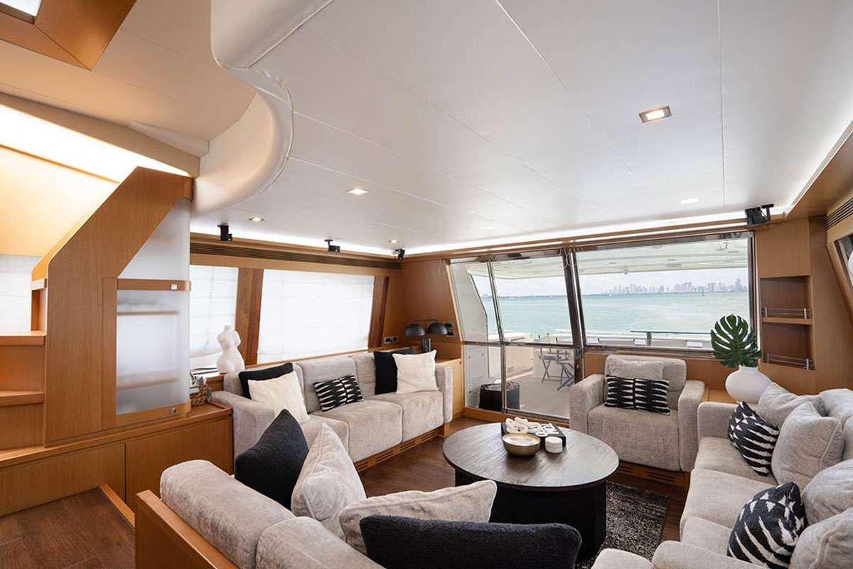 a living room with a large window aboard TWE11VE Yacht for Charter