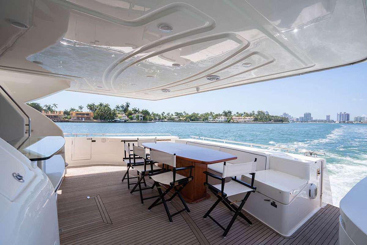a table and chairs on a deck aboard TWE11VE Yacht for Charter