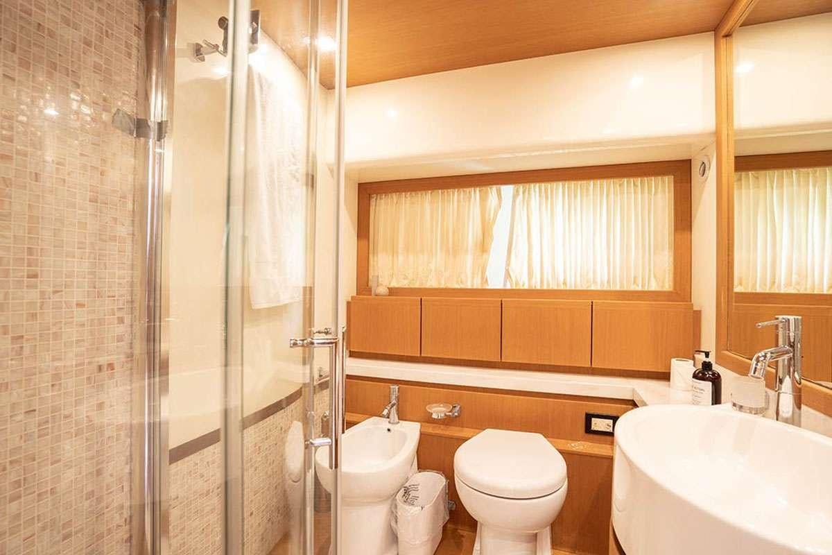 a bathroom with a toilet sink and a shower aboard TWE11VE Yacht for Charter