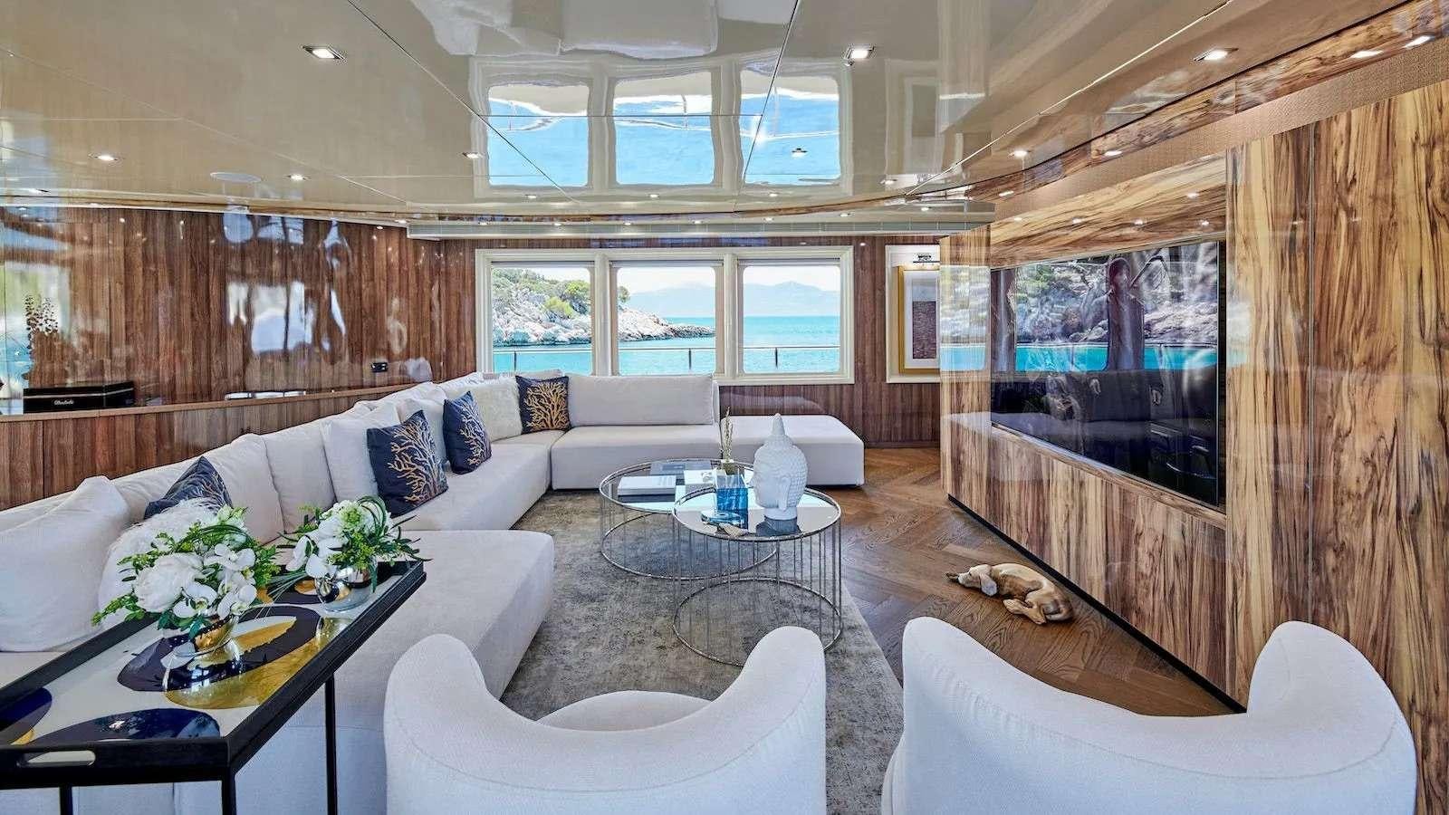a living room with a large window aboard PROMETHEUS I Yacht for Charter