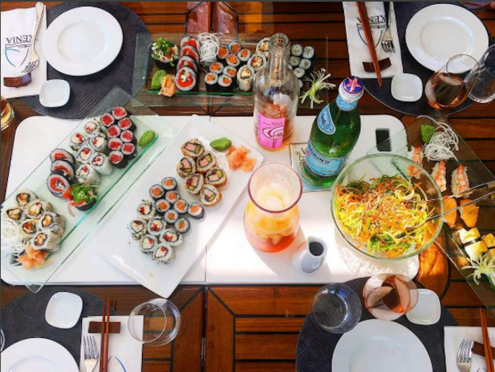 a table with plates and food on it aboard SUNREEF ECO 80 2024 Yacht for Charter