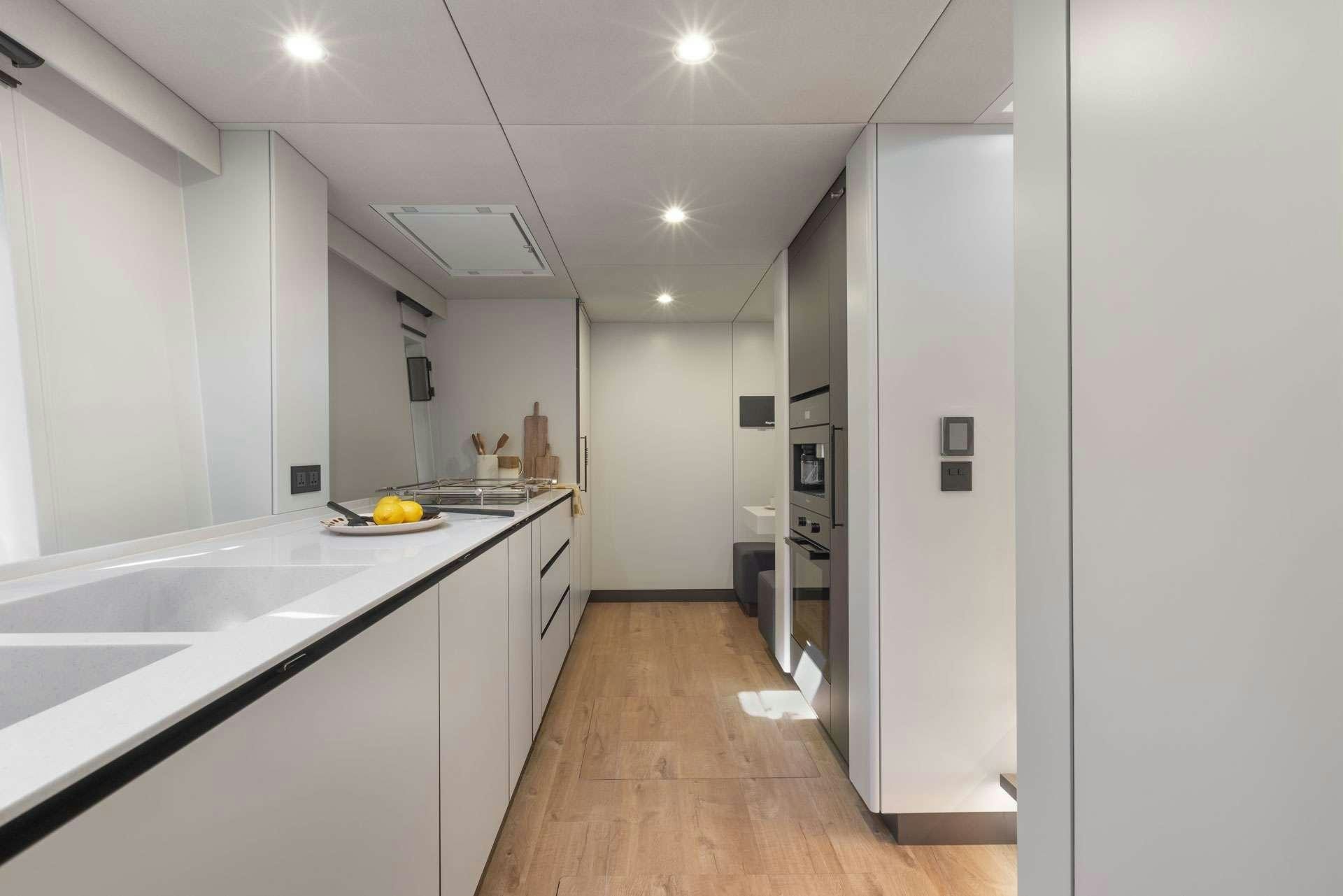 a kitchen with white cabinets aboard SUNREEF ECO 80 2024 Yacht for Charter