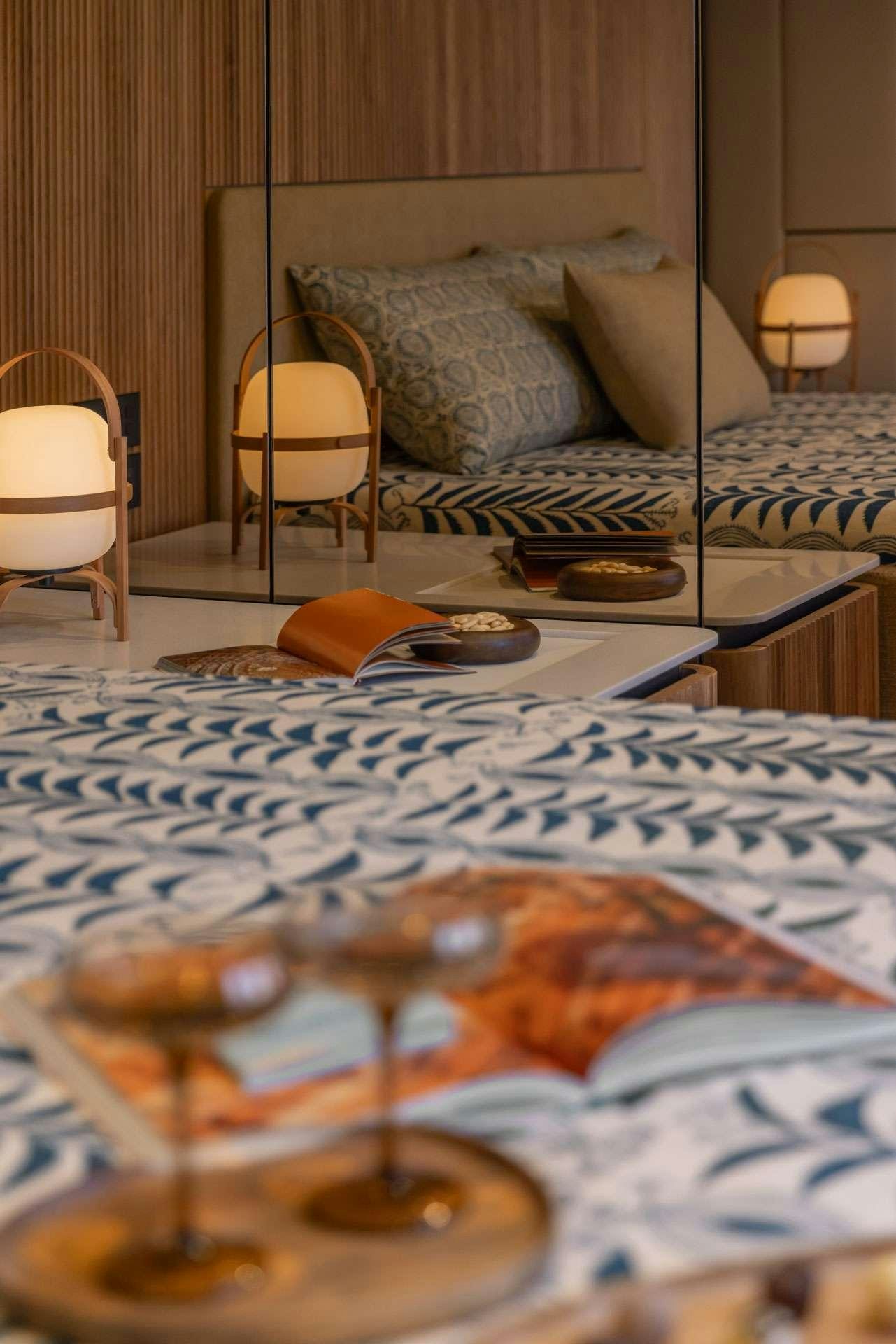 a bed with a table and chairs aboard SUNREEF ECO 80 2024 Yacht for Charter