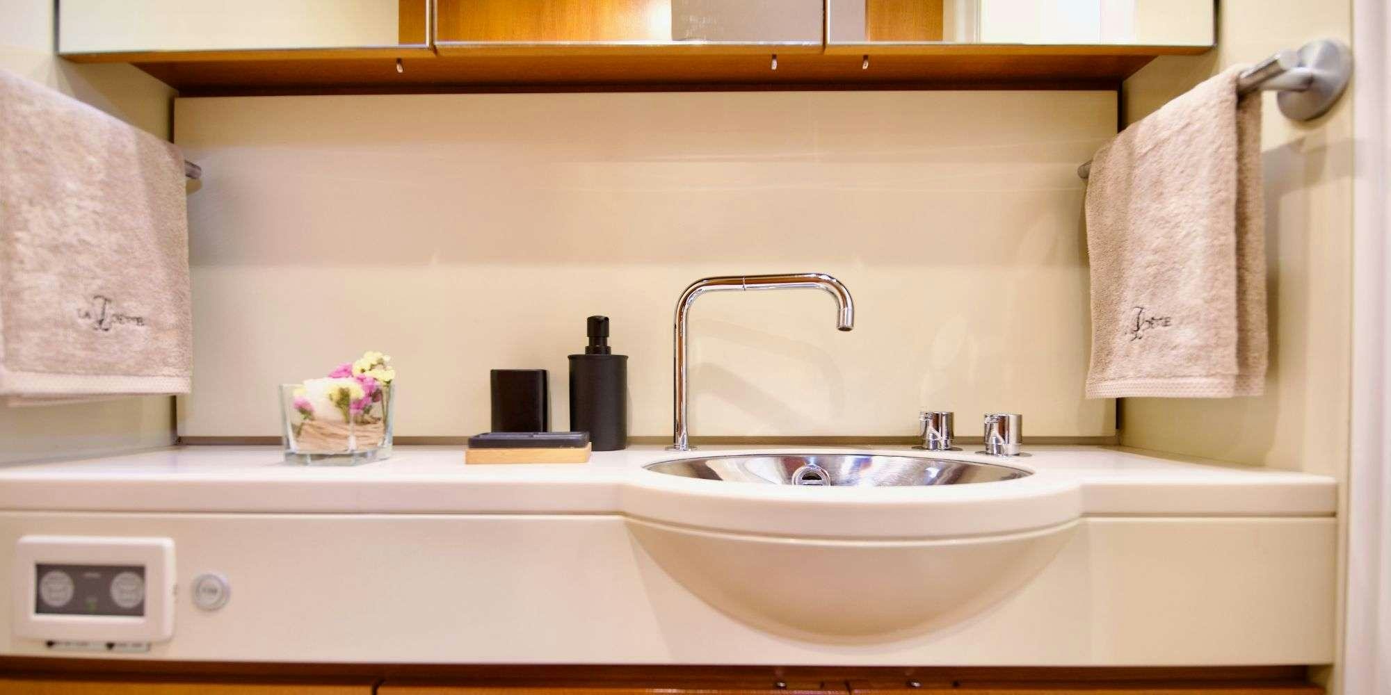 a sink and towels in a bathroom aboard LA LOEVIE Yacht for Charter
